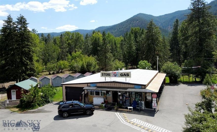 This home comes with an RV park, store, cabin rentals, tent sites and mini storage! Located just 12 minutes East of Missoula, MT with easy access on and off of I-90. This 6.25 acre property is turnkey and up and running with great revenue. This property has a beautiful setting with mature trees, playground and well maintained common areas. The new owner could live on-site in the 1 bed, 1 bath self-contained apartment or take over one of the many campsites or cabins. Below the apartment and store is a large, unfinished basement for future living spaces or storage. The RV park has 14 pull through sites and 12 back-in sites, 10 tent sites, 6 dry cabin rentals, shower/laundry facility 19 small storage shed rentals, two 10'X20' sheds, one 20'X30' shop/garage with two bay doors. There is an RV dump station located on site, as well as a large propane tank for filling guests and smaller tanks. There is a beer and wine license for the convenience store. Also included in the sale is a John Deere mower, golf cart and Kubota side by side with plow. Convenience store inventory sells with the property. Owner financing may be considered with a full price offer and/or adequate down payment. Public access to the Clark Fork River is right across the street. Showings by appointment only.