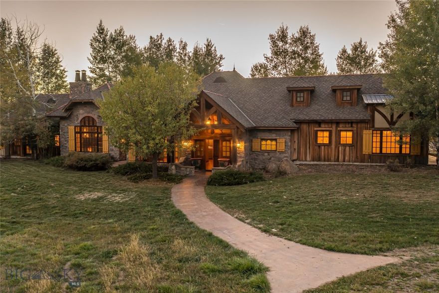 Set on approximately 40 acres at the foothills of the Bridger Mountains, 10669 Gee Norman Road offers space, privacy, and a strong connection to the surrounding landscape. A year-round creek flows through the property, and a private pond and open meadows create a setting that feels peaceful and expansive, with frequent wildlife sightings throughout the seasons.

The single-level, European-inspired mountain home spans 6,114 square feet and features four bedrooms and four and a half bathrooms. One bedroom includes built-in bunk beds, adding flexibility for guests or family. The primary suite is thoughtfully designed with a separate private den or office, its own laundry area, and direct access to outdoor patios. Character details are woven throughout the home, including built-in bookshelves and three fireplaces that add warmth and presence to the living spaces.

Large windows bring in natural light and frame views of the surrounding mountains and the city of Bozeman below. The open living, kitchen, and dining areas flow easily together while still feeling defined and comfortable for everyday living or entertaining. Nearly every room opens to a private patio with a snowmelt system, allowing the outdoor spaces to be enjoyed year-round. An outdoor firepit extends the living space and creates a natural gathering spot.

The home offers a gracious entrance foyer for guests, while daily life is made easy with a functional mudroom entry from the attached three-car garage and a centrally located laundry room in addition to the primary suite laundry. While the setting feels quiet and removed, the property remains conveniently located just a short drive from downtown Bozeman, Belgrade, and Bozeman Yellowstone International Airport. Taken together, the land, setting, and thoughtful design create a home that feels purposeful, comfortable, and deeply connected to its Montana surroundings.