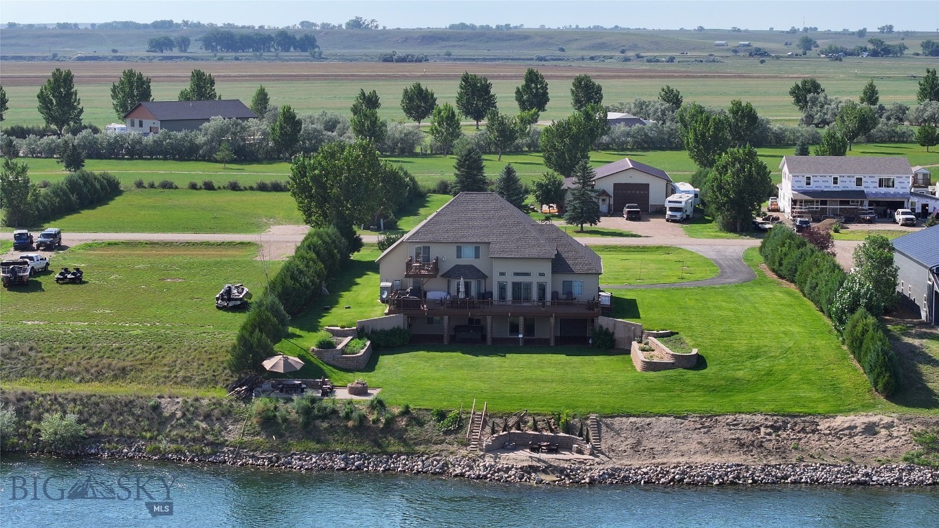 Welcome to 18 Idlewild Drive, a rare chance to own a spacious 4,218 sq ft riverfront home in the quiet Idlewild Park subdivision. With 5 bedrooms, 4.5 bathrooms, two full stories plus a partial basement, this property was designed for comfort, entertaining, and the Montana lifestyle. Features include two en suite bedrooms, multiple patios, and stunning river views. Even better — this home is being sold fully furnished, mineral rights convey, and it comes with exclusive access to a future private 9-hole golf course at neighboring Kirkland Estates through a membership offered with the purchase that is being built right now. Enjoy the bright, open layout with expansive windows overlooking the Missouri River on any level from the patios. The spacious kitchen with ample cabinetry, counters, and island seating makes it an amazing home for a weekend getaway or to move out to Northeastern Montana to enjoy the peaceful space in the quiet country. There's many additional bedrooms that offer flexibility for guests, family, or possible short term rental.
This property also features central heating and cooling for year-round comfort with unparalleled fishing in the surrounding area that makes this a fisherman's paradise. You can cast a line out your backyard, or head south and launch your boat into Fort Peck Reservoir to fish any number of species. Don't miss this opportunity to own this one of a kind property!