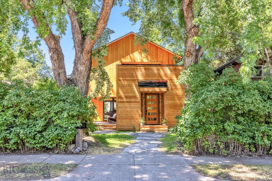 Welcome to Your Urban Treehouse Retreat. Thoughtfully designed by a local architect and just completed, this one-of-a-kind home with ADU that offers the perfect blend of modern luxury and natural serenity. With over 1000 square feet of decks, you’ll enjoy exceptional outdoor living among the trees, ideal for relaxing, entertaining, or simply soaking in the peaceful surroundings. Step inside to discover a light-filled interior featuring clean, modern lines and high-end finishes throughout. Southern exposure brings in beautiful natural light, while radiant in-floor heat in the tiled surfaces and classic hot water radiators ensure year-round comfort on the wood surfaces. The main level includes a spacious mudroom, an open dining area, and a large butler’s pantry, perfect for everyday living and hosting alike. Upstairs, all three bedrooms are thoughtfully positioned, with the primary suite opening onto a private upper deck that is hot tub ready to be your personal spa under the stars. Adding flexibility and space, the property includes a beautifully finished ADU above the one-car garage with additional off-street parking. The ADU mirrors the main home’s quality of finishes with a bright and open living, dining, and kitchen area. Best of all, it also features its own expansive rooftop deck, ready for morning coffee or evening sunsets. Tucked into a mature, established neighborhood, you’ll love the privacy and tranquility of the setting while still enjoying easy walkability to downtown, nearby trails, and all the amenities Bozeman has to offer. Experience the perfect blend of modern design, thoughtful function, and a prime downtown location.