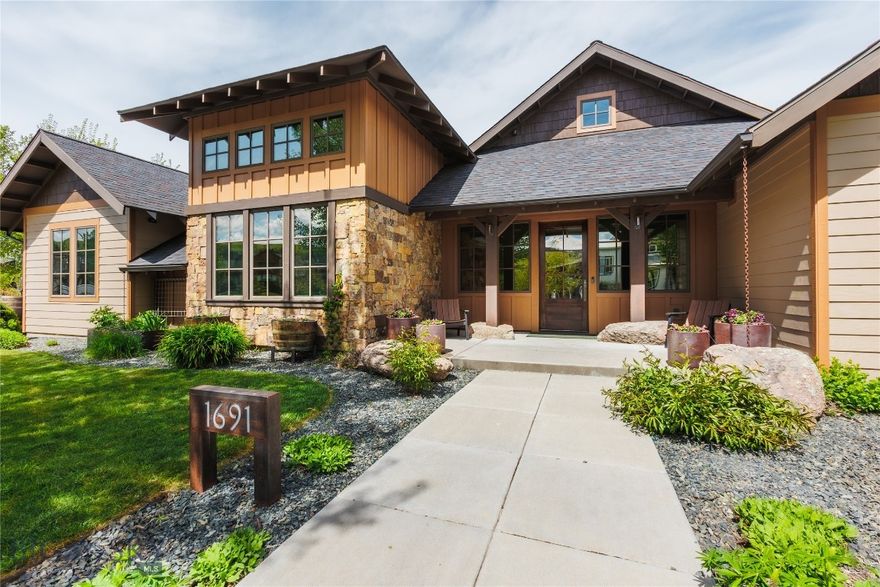 Nestled in the highly sought-after Legends at Bridger Creek community, this beautifully maintained 5-bedroom, 3-bath home offers 3,094± square feet of thoughtfully designed living space on a .243-acre lot with stunning views of the Bridger Mountains and Story Hills. Combining timeless craftsmanship, quality finishes, and exceptional outdoor living, this home captures the best of Bozeman living.

Inside, wide plank American Hickory floors, Andersen wood windows, stone accents, and Bosch appliances create a warm mountain-modern feel. The functional floor plan offers both privacy and flexibility, with the primary suite tucked privately on one side of the home while the additional bedrooms are situated on the opposite wing. A spacious upstairs bonus room provides additional living space, while the dedicated office features a large wall of windows and abundant natural light.

Designed for passive solar living, the home enjoys excellent winter sun exposure with limited summer heat intake. Additional features include two hot water heaters, ample storage, and an oversized attached two-car garage with one extra-long bay ideal for larger vehicles and gear.

Outdoor living shines with beautifully maintained landscaping featuring mature trees, flowers, shrubs, garden beds, grape vines, and apple trees. The covered back patio is built for entertaining with two outdoor fireplaces, a gas line for BBQ, and a recessed concrete area ready for a firepit. Wood garage doors and low-maintenance exterior finishes complete the home’s exceptional curb appeal.

Located just minutes from Bridger Creek Golf Course, Story Mill Park, downtown Bozeman, trails, and Bridger Bowl Ski Area, Legends at Bridger Creek offers an unbeatable blend of recreation, convenience, and community.