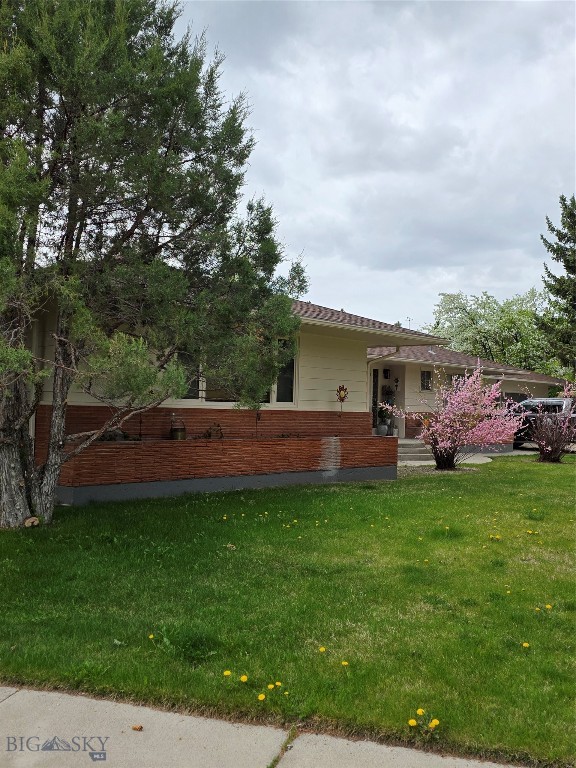 Open the door to this spacious mid century modern home at 606 S Arizona Street on a fully landscaped corner lot near UM Western. Step in one of three birch outside doors and marvel at the craftsman and character of this well constructed home. The large eat-in kitchen boast birch cabinets, updated counter tops and back splash, newer appliances, and a pet feeding station. Meander down the hall past a 1/2 bath to a row of storage and coat closets. The comfortable living area features several build-ins to display your keepsakes , a large picture window , and new carpet. The primary bedroom has custom closets and a retro-vibe tiled en-suite bathroom. Two additional bedrooms , a bathroom with accessible shower and tons of storge are situated off the living area. Enjoy the Sunroom with over 40' of windows facing the fenced back yard. A pass- thru window to the kitchen offers ease for entertaining. A newly renovated basement with 1500s.f. lends itself to multi generational living, short term rental or extra space for a large family. Two basement bedrooms are non-comforming. All rooms, bedrooms, bathroom, kitchen, laundry and storage are accessible through the garage or the main floor living room. Property has an attached 3 car garage with 2 storage rooms and a work bench. The outside brick planters, UGS and mature trees provide privacy and ease of maintenance.