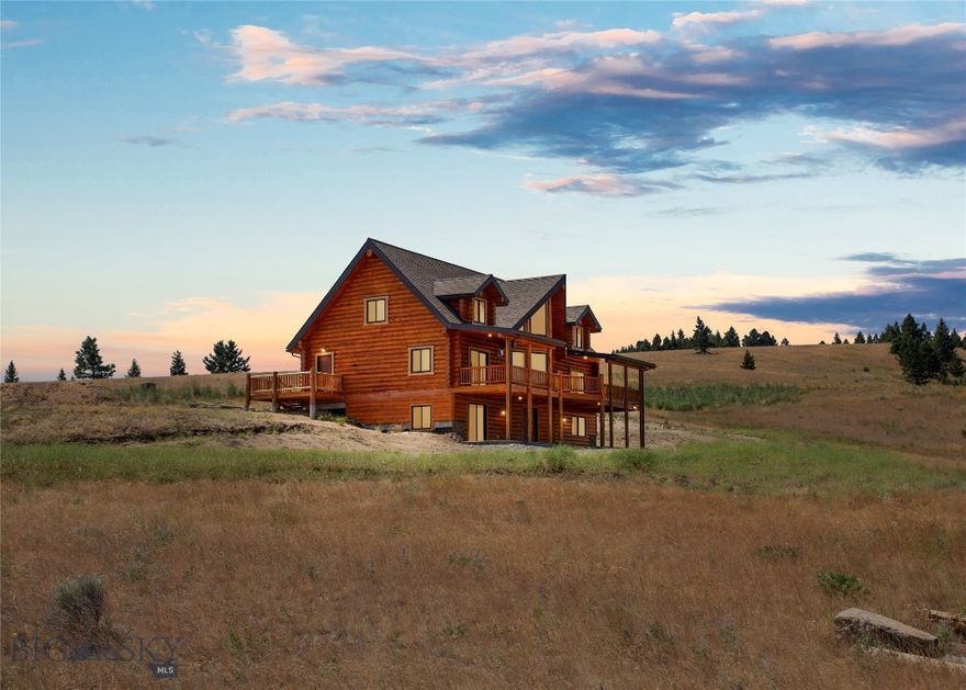 Introducing an exceptional opportunity in Butte, Montana—a stunning, brand-new log home situated on 20 acres. This impressive property features 4 bedrooms, 5.5 bathrooms, and a walk-out basement, meticulously crafted with logs and home plans from Lazarus Log Homes in Whitefish, Montana. Built in 2024 and recently occupied for 2 months, the home and garage are insulated with Corbond for optimal energy efficiency, complemented by sturdy 10-inch logs. The interior showcases a beautiful kitchen and dining area seamlessly integrated with the living space, enhanced by abundant natural light through expansive windows. The main level includes a convenient laundry room and a cozy gas fireplace. A triple car finished garage with a 25-foot apron offers extensive storage and parking. Additionally, a 30'x40' Corbond-insulated shop with 3 overhead doors and a service door awaits, perfect for storing Montana toys. Landscaping, including a stamped concrete patio on the north-facing front side, is scheduled to commence soon. The basement is designed for flexible living, featuring plumbing for a kitchen, air conditioning, a heater, and an on-demand hot water tank. The property benefits from a productive well yielding 25 gallons per minute with a 60-gallon pressure tank, supplemented by an owned underground 1000-gallon propane tank. An annual HOA fee of $400 covers road maintenance, ensuring year-round accessibility. Located just minutes from town, this property offers frequent wildlife sightings, including moose, deer, and elk, visible from the spacious deck and patio. Its proximity to State and BLM lands provides endless recreational opportunities. Whether you're entertaining guests or seeking tranquility amidst nature, this meticulously designed home offers the perfect backdrop for your Montana lifestyle.