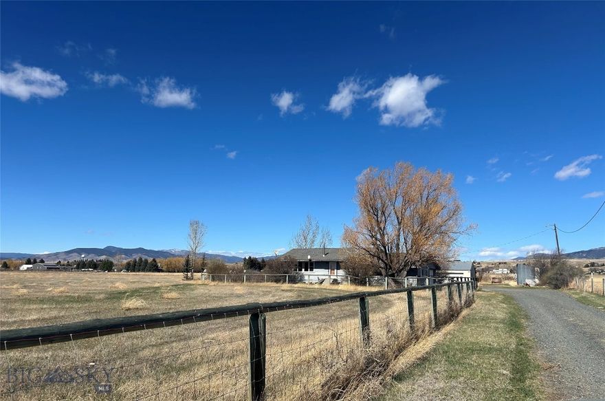 This property is in a great location with NO Covenants. It has 2bdrms inside the house with a 3/4 bath. The attached garage has a 3rd bedroom with a full bath. The property is a living estate with great potential.There is 14 x 22 hay barn (3sided), 15 x 23 welding shed(no power), 40 x 26 metal shop and 12 x 20  horse Lean to. Hand line is included. Acreage watered by irrigation well . House has a separate well 60 gpm. Great opportunity to remodel/build your home and business here. 
There are pear, apple, crab apple, flowering almond, chokecherry trees. Also. cottonless cottonwoods, lilacs and bulbs on the property around the house area.
The house has original wood floors, new windows and an open floor plan. It is fenced in the front yard. The  property perimeter is fenced. This property needs TLC but has so much to offer to the right buyer. Come see it.