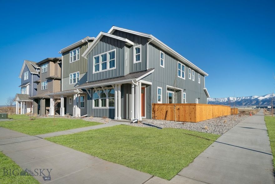 Ideally location on a premium corner homesite, this home has unblocked views of the Bridger Mountains from the patio and rear of the home. Plan 2 welcomes you home with a charming front porch and a bright, inviting interior designed for connection and comfort. The open-concept main floor features a spacious great room with 9-foot ceilings and large front-facing windows, creating a light-filled space where living, dining, and kitchen areas come together effortlessly.

Sliding glass doors extend the living space to a side patio, making indoor-outdoor living easy and natural. Upstairs, a generous loft offers flexible space for a home office, media room, or play area, while three well-sized bedrooms provide room for everyone to unwind.

Included designer options and upgrades:
• Sterling Ludington apron-front farmhouse kitchen sink
• Satin nickel hardware throughout
• KitchenAid appliance package #1 (refrigerator not included)
• Clean Water Package
• Kitchen cabinetry with white upper cabinets and Buckskin lower cabinets
• White cabinetry in the primary bathroom
• Buckskin cabinetry in the laundry room and secondary bathroom
• Custom tile selections
• Calacatta Rama kitchen countertops
• Miami White countertops in bathrooms and laundry room

With its welcoming layout, flexible living spaces, and curated finishes, this home offers a perfect blend of style, functionality, and everyday comfort.