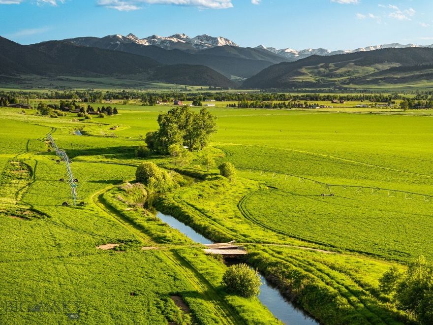 Introducing The Baden-Baden Ranch — a rare legacy offering in Gallatin Gateway, Montana, now available for the first time since 1970. Spanning approximately 290± acres across three legal parcels (~104.7 acres, ~20.56 acres and ~164.7 acres) each with its own designated homesite, this ranch showcases some of the Gallatin Valley’s most fertile and scenic land. With 165± acres of center-pivot irrigated cropland supported by historic 1866 water rights from the West Gallatin Canal, the property is as productive as it is beautiful. A spring-fed trout pond and Wortman Creek enhance both the recreational appeal and functionality.
Panoramic views of the Spanish Peaks, Bridger Range, and the iconic Flying D Ranch surround the property, offering the quintessential Big Sky Country backdrop. Wildlife is abundant—elk, deer, moose, and a wide variety of birds including sandhill cranes, ducks, geese, and bald eagles regularly visit the land. Protected by a GVLT conservation easement, the ranch also features ~4 miles of well-maintained roads, with natural gas and electricity available for future improvements.  The ranch is ideally located 16 miles to Bozeman Yellowstone International Airport, 14 miles to Downtown Bozeman and 31 miles from Big Sky! Whether you're seeking a private retreat, working agricultural operation, or a long-term investment in one of Montana’s most sought-after valleys, the Baden-Baden Ranch offers unmatched potential in an extraordinary location!