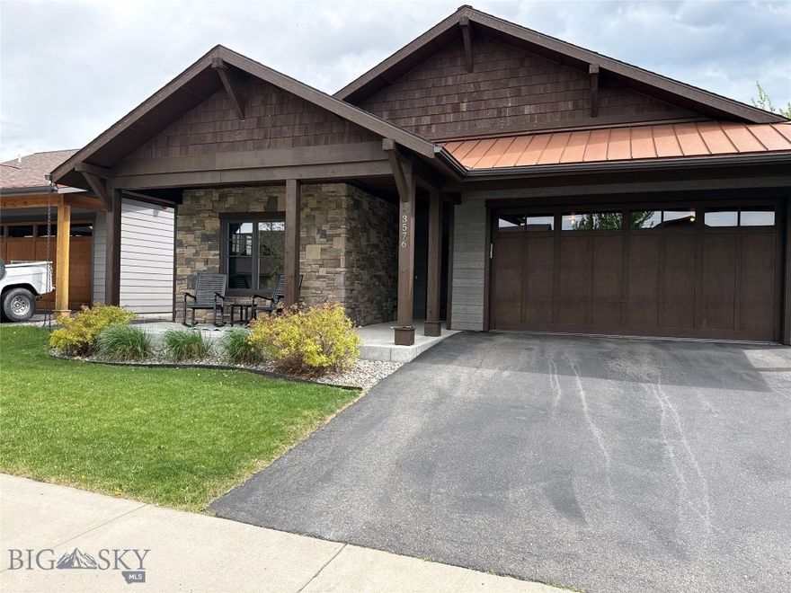 Some neighborhoods land in the sweet spot between elbow room and everything you actually need. The Crossing Subdivision is one of them. 3576 Lolo Way, sits right in the heart of everything, and is tucked into the quiet of the Crossing Subdivision. One block from Gallatin County Regional Park, featuring the Dino Park the kids love and the fenced off-leash area with ponds the dogs love more. This neighborhood landed in the sweet spot between elbow room and everything you actually need.

The house is a well-built craftsman with stacked stone detail, copper roof accent, and shake siding. Inside: an open living space anchored by a gas fireplace and built-in shelving, a primary suite that's quiet and finished, and a third bedroom that's been used as a study; the kind of flex space that earns its square footage whether you need a desk or a door that closes.

Kitchen comes equipped: gas range, stainless steel appliances, oversized granite island with room for every project, be it your perfect loaf of bread or the last minute project. Washer and dryer set with pedestals convey. Covered back patio with a manual shade for the summer south facing sun, fenced yard, room to exhale.

Virtually staged photos enhance the details of what the space can hold. What it already has is the part worth seeing.