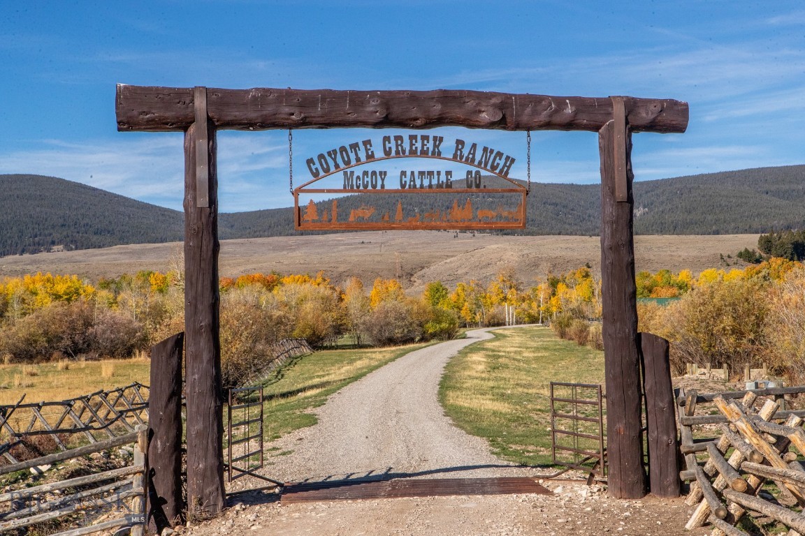 Nestled in the heart of Montana ranch country near Grant, the Coyote Creek Ranch encompasses 2,802± deeded acres surrounded by breathtaking views of the Pioneer Mountains. Steeped in history, this region of Horse Prairie is where the Lewis and Clark Expedition met Sacagawea’s Lemhi Shoshone people in 1805—an area long valued for its open grasslands, water, and early ranching heritage.
Coyote Creek Ranch is a rare combination of productivity, recreation, and beauty. The property features abundant live water from Coyote, Jensen, and Lodgepole Creeks, plus a well-stocked trout pond. Approximately 770± acres are irrigable, providing fertile meadows for hay and grazing. Sub-irrigated and flood-irrigated bottoms are lined with aspens, meandering creeks, and rich wildlife habitat. The ranch also includes valuable grazing leases on adjoining USFS, State, and BLM lands.
Currently operated as a summer grazing unit, the ranch has historically supported around 500+/- cow/calf pairs annually, utilizing both deeded and leased acreage. In 2025, the owner successfully ran 300+/- pairs and 300+/- yearlings. Fully fenced and cross-fenced with well-designed corrals, this is an efficient, turnkey cattle operation with dependable carrying capacity and diverse forage.
For the sportsman, Coyote Creek Ranch is an outdoor paradise. Wildlife is abundant—elk, whitetail and mule deer, moose, bear, upland birds, and trout thrive here. Located in Hunting District 329, the ranch lies within an over-the-counter elk area for residents and borders thousands of acres of public land, offering exceptional hunting and recreation year-round.
Improvements balance rustic charm with modern function. The Whisper Creek log home overlooks the trout pond and Horse Prairie, featuring 3 bedrooms, 4 baths, a primary suite with jetted tub and walk-in tile shower, and a finished walk-out basement with family and rec rooms. A wraparound porch captures sweeping 360° views. A detached 30' x 45' garage provides ample storage. The guest or manager’s home includes 3 bedrooms and 2 baths for comfortable living. Don't forget about the trapper's bunk house too! A 40' x 60' Cleary building with horse stalls, tack and feed areas, and covered overhangs completes this well-equipped ranch headquarters.
Coyote Creek Ranch offers the ideal balance of production, recreation, and Montana beauty—a true legacy property beneath the Big Sky.