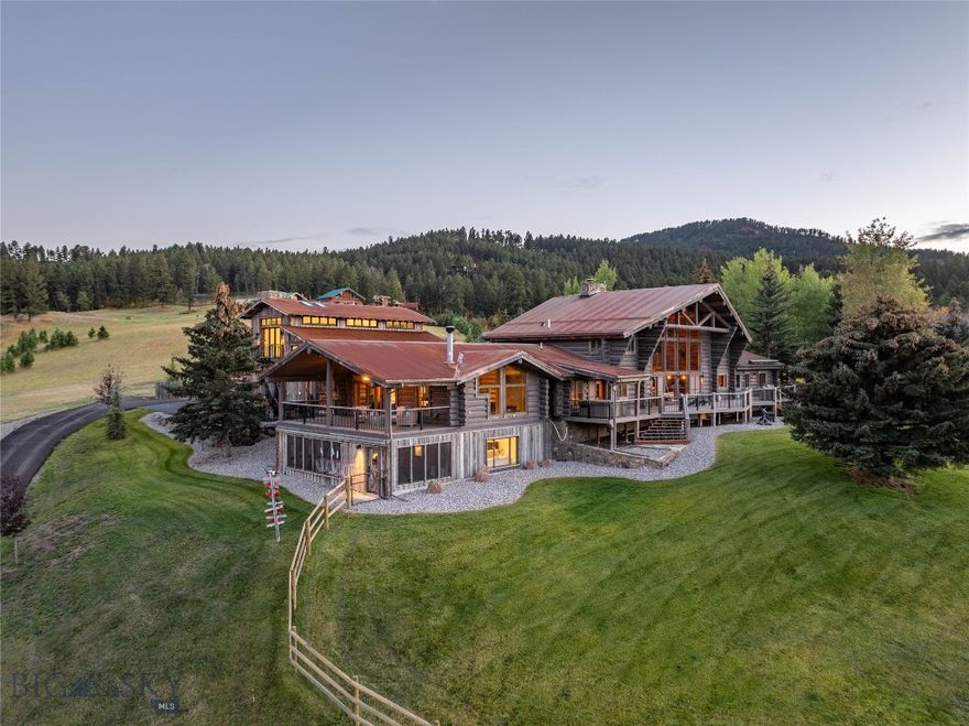 Welcome to Incognito Ranch, where elevated luxury pairs seamlessly with the rustic soul of a Montana guest ranch. This spectacular 4-bedroom lodge-style residence spans 8,524 SF, accompanied by a 1,172 SF attached art studio/guest apartment, all set on 29.99 acres of pure serenity overlooking the iconic Bridger Mountains.

Recently refreshed throughout, the home feels both timeless and new. The grand, light-filled entry sets the tone, warm, inviting, and dramatic. The main-floor primary suite lives like a private retreat, featuring a spa-inspired bath with a copper soaking tub, an elegant custom closet, sitting area with wood-burning stone fireplace, covered balcony, and unobstructed mountain views.

The main level continues with two additional bedrooms connected by a jack-and-jill bath, a stately Great Room with floor-to-ceiling windows, a beautifully appointed kitchen with walk-in pantry and temp-controlled wine room, and a dream laundry/mudroom with dual washers/dryers, lockers, and powder bath.

The upper floor hosts another bedroom, full bath, and cozy library/TV room. The lower level offers a spacious family/game room with kitchenette, 3/4 bath with sauna, home gym, and generous bunk room opening to a screened porch, perfect for guests or large gatherings.

Beyond the home itself, the garage spaces elevate the property to a new level. In addition to the 4-car heated garage, a 2,100 SF shop was added with an 800 SF art studio above. With 3,600 SF of heated garage space total, this is a paradise for car collectors and recreation enthusiasts: epoxy floors, LevRack system, auto lift, workshop with sink and laundry, and pull-through bays. The art studio, private yet connected, was designed for creativity, solitude, and inspiration.

Step outside and Montana takes over. Bask in sweeping views of the Bangtail and Bridger ranges. Cast a line in your stocked pond from the private dock. Explore your own hiking, snowshoeing, and ATV trails.

Horse lovers will appreciate two pastures, a 5+ stall barn with tack room and wash rack, hay barn, two turnout paddocks with year-round auto waterers, and a 100x200 outdoor arena with specialized footing. A nearby guest/caretaker cabin and separate guest bath enhance the ranch experience.

Incognito Ranch is a rare blend of luxury, privacy, recreation, and breathtaking mountain beauty. A true sanctuary and an opportunity not to be missed.