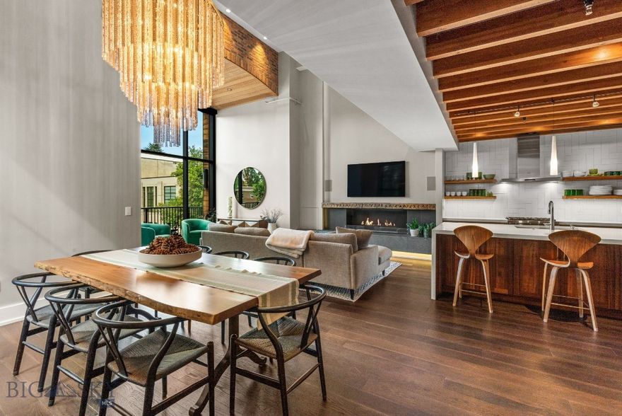 Welcome to this one-of-a-kind corner unit in the sought after Willson Residences. This contemporary-urban retreat lies right in the heart of
downtown Bozeman on the famous Main Street. Every detail has been carefully curated, culminating in the ultimate confluence of luxury and
ease of living. This turn-key oasis boasts soaring vaulted ceilings, floor-to-ceiling windows drenching the space in natural light, and a cozy,
custom fireplace anchoring the great room. The open layout showcases exposed brick walls, exquisite light fixtures, and striking steel accents,
seamlessly blending structural and decorative elements. The chef's kitchen boasts sleek quartz countertops, ample high-end cabinetry, and
premium stainless steel appliances. Featuring two full bedrooms and two bathrooms, this downtown condo makes the perfect primary residence,
or convenient lock-and-leave retreat, with plenty of space for visiting family or friends. Housed within the repurposed Willson School, originally
built in 1913, this residence combines modern luxury with rich architectural history. Sitting right in the heart of all the downtown Bozeman action,
right on Main Street, no detail has been left untouched. The unit includes 1 parking space and 1 storage space in the private-access, lower level
parking garage. Don’t miss this extraordinary opportunity to live steps away from Bozeman’s vibrant downtown scene, with easy access to
shopping, dining, skiing, and the Bozeman Yellowstone International Airport.
