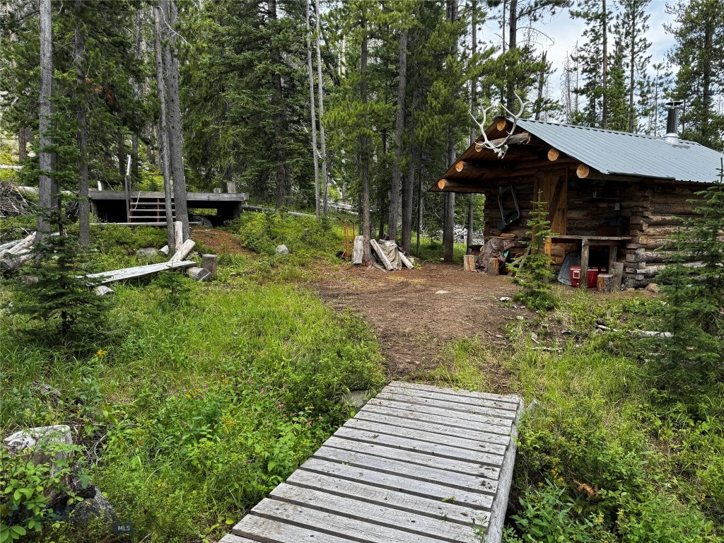 Outdoor Enthusiasts won't want to miss this one! 20.66 acres surrounded by National Forest. Enjoy a private hunting cabin with a wood stove, generator, and 2 tree stands. A year-round creek runs through the property, and the area is known for its ample wildlife - elk, deer, bear, moose, etc. The seller is including a 20' x 12' guide tent for which he has built a platform deck. This property is off grid and currently accessible by ATV or foot traffic. Grab it before the season starts!