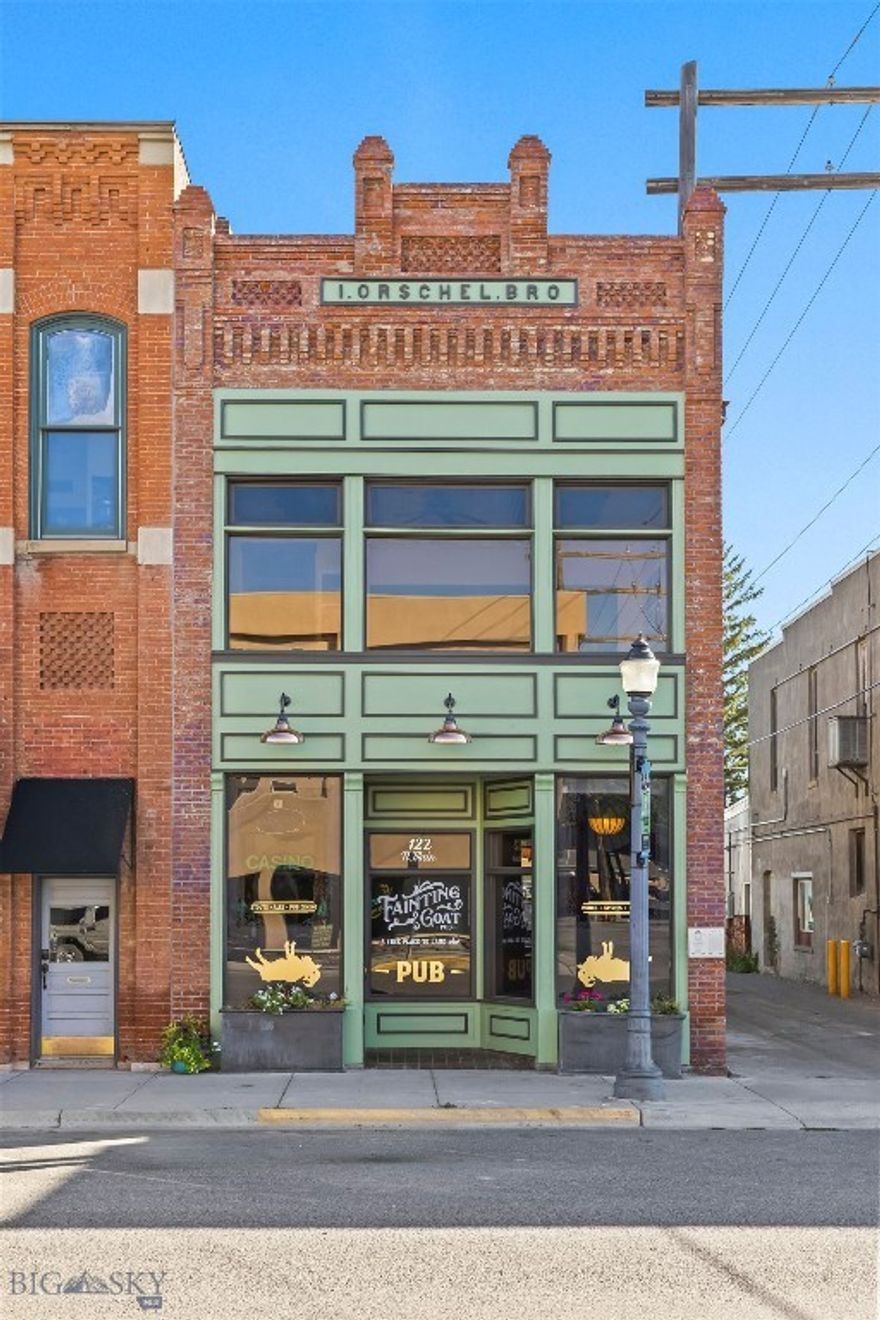 Prime Historic Downtown Livingston Investment Opportunity. Own a true piece of Livingston history with the iconic I. Orschel & Bros. building, prominently located at 122 N Main Street in the heart of the Historic District. Listed on the National Registry of Historic Places, this property offers a rare blend of preserved historic character, significant recent restoration, and steady income in one of Montana’s most desirable downtown locations. Originally home to a booming late-1800s clothing store, the building evolved into its current form in 1891 when the addition at 106 E Park Street was linked to 122 N Main, creating its distinctive L-shaped footprint with storefronts on both Main Street and Park Street. In recent months, the property has undergone extensive historical restoration to safeguard its legacy and ensure long-term stability. Skilled craftsmen carefully removed stucco from the brickwork, ground out deteriorated cement joints, and tuck-pointed the masonry, repairing and rebuilding damaged sections with new brick where needed. The facade has been a major focus, with rotted trim, jambs, moldings, and scrolls replaced, new framing installed where necessary, and all exterior surfaces scraped, sanded, treated with lead abatement primer, and repainted. Upper-level windows were removed, repaired, and reinstalled with new interior sills and trim, and the historic upper lettering was replaced with newly fabricated signage and back panels.  The entire outdoor deck area was also redone this summer. Currently, the entire main level (2,458 sq. ft.) and 1,356 sq. ft. of outdoor dining are leased under a Triple Net agreement to a long-established and successful food and beverage business, providing guaranteed income for investors. A 350 sq. ft. lower level serves the restaurant with restrooms and storage. The second story features soaring 12-foot ceilings and expansive windows that flood the space with natural light. While some areas await finishing touches, the upstairs holds outstanding potential for offices, loft residences, or creative studio space. One unit is already leased to the restaurant for storage, adding to the income stream. Additional updates include 2 new furnaces and hot water heater. With its prime location, extensive recent restoration, and guaranteed tenant income, the Orschel & Bros. building is more than an investment—it is a chance to own and preserve a living piece of Livingston’s historic core. Schedule your private tour today.