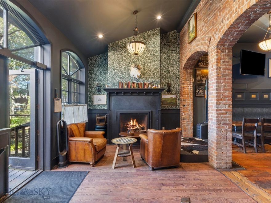 Prime Historic Downtown Livingston Investment Opportunity. Own a true piece of Livingston history with the iconic I. Orschel & Bros. building, prominently located at 122 N Main Street in the heart of the Historic District. Listed on the National Registry of Historic Places, this property offers a rare blend of preserved historic character, significant recent restoration, and steady income in one of Montana’s most desirable downtown locations. Originally home to a booming late-1800s clothing store, the building evolved into its current form in 1891 when the addition at 106 E Park Street was linked to 122 N Main, creating its distinctive L-shaped footprint with storefronts on both Main Street and Park Street. In recent months, the property has undergone extensive historical restoration to safeguard its legacy and ensure long-term stability. Skilled craftsmen carefully removed stucco from the brickwork, ground out deteriorated cement joints, and tuck-pointed the masonry, repairing and rebuilding damaged sections with new brick where needed. The facade has been a major focus, with rotted trim, jambs, moldings, and scrolls replaced, new framing installed where necessary, and all exterior surfaces scraped, sanded, treated with lead abatement primer, and repainted. Upper-level windows were removed, repaired, and reinstalled with new interior sills and trim, and the historic upper lettering was replaced with newly fabricated signage and back panels.  The entire outdoor deck area was also redone this summer. Currently, the entire main level (2,458 sq. ft.) and 1,356 sq. ft. of outdoor dining are leased under a Triple Net agreement to a long-established and successful food and beverage business, providing guaranteed income for investors. A 350 sq. ft. lower level serves the restaurant with restrooms and storage. The second story features soaring 12-foot ceilings and expansive windows that flood the space with natural light. While some areas await finishing touches, the upstairs holds outstanding potential for offices, loft residences, or creative studio space. One unit is already leased to the restaurant for storage, adding to the income stream. Additional updates include 2 new furnaces and hot water heater. With its prime location, extensive recent restoration, and guaranteed tenant income, the Orschel & Bros. building is more than an investment—it is a chance to own and preserve a living piece of Livingston’s historic core. Schedule your private tour today.