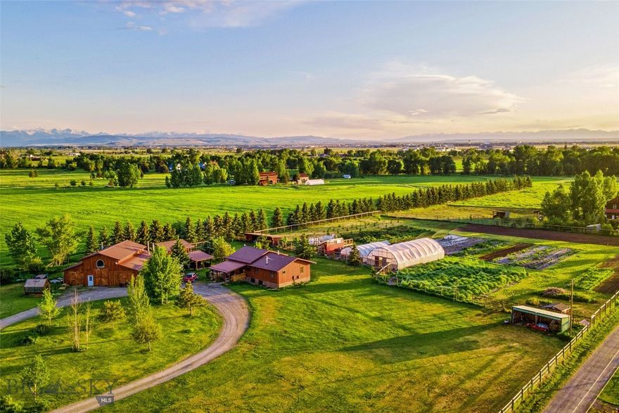 Nestled on 5.2 picturesque acres, this charming micro farm offers sweeping, unobstructed view that are truly to die for. Whether you're looking for a peaceful retreat, a hobby farm, or a base for your outdoor adventures, this property delivers the perfect blend of rustic charm in Big Sky Country-WITH NO COVENANTS. After a renovation featuring a brand-new custom kitchen & all-new flooring throughout, this home is ready for its new owners. With 4 bedrooms, 2 bathrooms, & 2 inviting living rooms, there's plenty of space for family, guests, or entertaining. Just off the kitchen, you'll find a versatile walk-in pantry that doubles as a home office, adding both convenience & functionality to your life. Outside, the land features a large shop with concrete floors, a finished office/studio/retail space with new flooring & wood stove for heat, a walk-in refrigeration unit, & a second-floor storage area-perfect for business, creative projects, or storage. This property is a dream come true for homesteaders, hobby farmers, or anyone seeking a self-sufficient lifestyle. Additional outbuildings include two equipment/loafing sheds, two greenhouses, and two hoop houses to support your growing needs. Water is abundant with two wells-one for domestic use & another for agricultural purposes. The garden area is fully fenced with 6'6" fencing & includes multiple gates for easy access. For outdoor growing, enjoy 12 raised garden beds, 350 raspberry bushes, & 275 honey berry bushes-an incredible start for a thriving berry harvest or farm stand. If a farming operation isn't what you're after-no problem. This property is perfectly suited for a smaller-scale hobby farm or animals alike. Bring your horses, goats, chickens, or other animals-there's plenty of space & infrastructure to support them. The chicken coop offers a secure, fenced enclosure, allowing your birds to enjoy the benefits of "free ranging" while staying safe from predators. There is plenty of power available-one 200 amp service for the house and shop and another 200 amp service for the irrigation clock & agricultural well. The property taxes have been reassessed to allow for the deduction for the land being used for agriculture purposes. With stunning views of the Bridger Mountains & close proximity to Bozeman, this property offers the perfect blend of peaceful country living & convenient access to town. Wake up to the sound of birdsong & end your days with sunsets that will truly take your breath away.