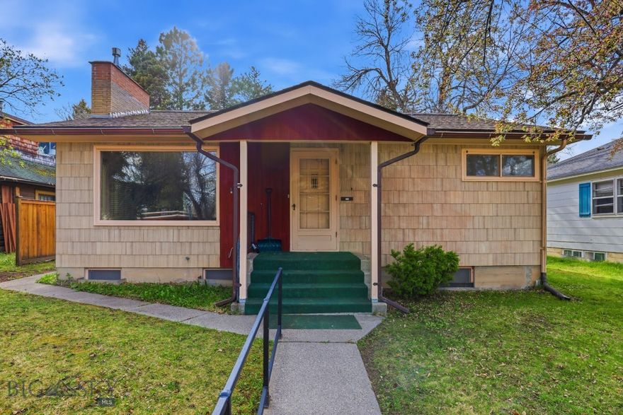 Step back in time with this 1950s-era home in downtown Bozeman. Located just four blocks from the Montana State University campus on a quiet street, the property sits on a 7,000 sq ft lot with alley access and a detached two-car garage. Inside, you’ll find original hardwood floors, retro tile, vintage fixtures, and built-in shelving—features that offer character but will benefit from updates. The home includes five bedrooms and a covered back patio, along with a backyard that has mature fruit trees. Fifth bedroom would make a great rec room or bonus room.  With its prime location, this property presents an opportunity for modernization or investment.
