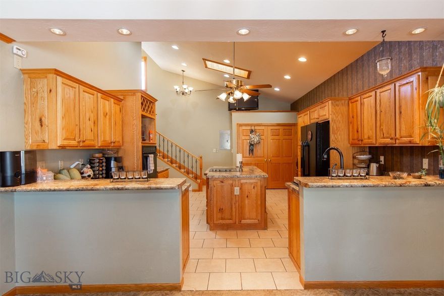 There’s something immediately welcoming about 106 E Hamilton Street—a home that feels comfortable, thoughtfully designed, and easy to live in. Mature trees, a spacious yard, and a covered front porch set the tone, offering a charming place to enjoy your morning coffee or greet neighbors as they pass by. Inside, the bright and airy kitchen serves as the heart of the home, featuring vaulted ceilings, skylights, a large island, abundant oak cabinetry, and generous counter space. Just off the kitchen are a convenient half bath, laundry area, and access to the oversized two-car garage with built-in storage. The dining area flows naturally from the kitchen and opens to the covered front porch through sliding glass doors, making indoor-outdoor living feel effortless. Tucked alongside the dining room, a wood-burning stove adds warmth and character while efficiently heating the main level.  The living room offers ample room to relax or entertain, while the main-floor primary suite provides a private retreat with a recessed ceiling and ensuite bath. Upstairs, two oversized bedrooms filled with natural light share a full bathroom, offering flexible space for guests, family, or a home office. Solid wood trim and doors throughout add timeless warmth and craftsmanship. Ideally located in the heart of Sheridan, this home offers easy access to Downtown, parks, schools, the library, medical facilities, and the community swimming pool—making everyday convenience one of its greatest amenities. With 3 bedrooms, 2.5 bathrooms, and 2,009± square feet of inviting living space, 106 E Hamilton is ready to welcome its next owners. Schedule your showing today and don’t forget to explore the virtual tour.