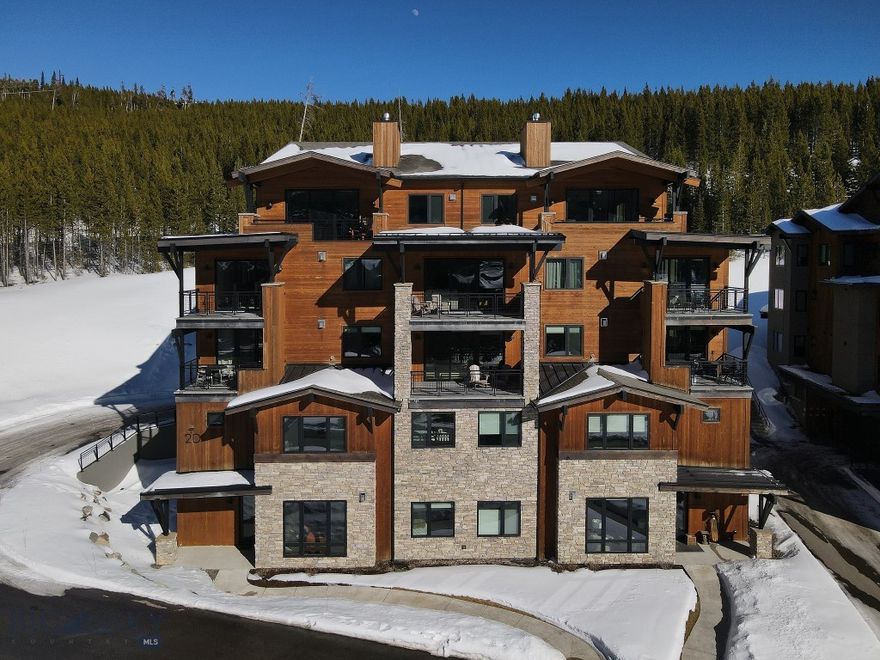 This beautifully appointed 4 bedroom, 3 bath, mountain modern condominium offers effortless comfort and iconic views of Lone Mountain right from your doorstep.
Located on the ground floor, the residence provides easy access and seamless indoor–outdoor living, with expansive windows that frame Lone Mountain in every season — from snow-covered winter mornings to vibrant summer sunsets. Clean architectural lines, warm natural textures, and thoughtfully curated finishes create a refined yet relaxed alpine retreat.
The open-concept living space is designed for gathering, featuring a spacious great room that flows into a well-appointed kitchen and dining area — perfect for entertaining family and friends after a day on the slopes or trails. 
Just steps away, enjoy the Mountain Lake's hot tub, pool, workout facility ideal for unwinding under the big Montana sky.
Whether you’re seeking a full-time residence, mountain getaway, or investment opportunity, this exceptional condominium combines modern design, convenience, and breathtaking Lone Mountain views in one unforgettable setting.