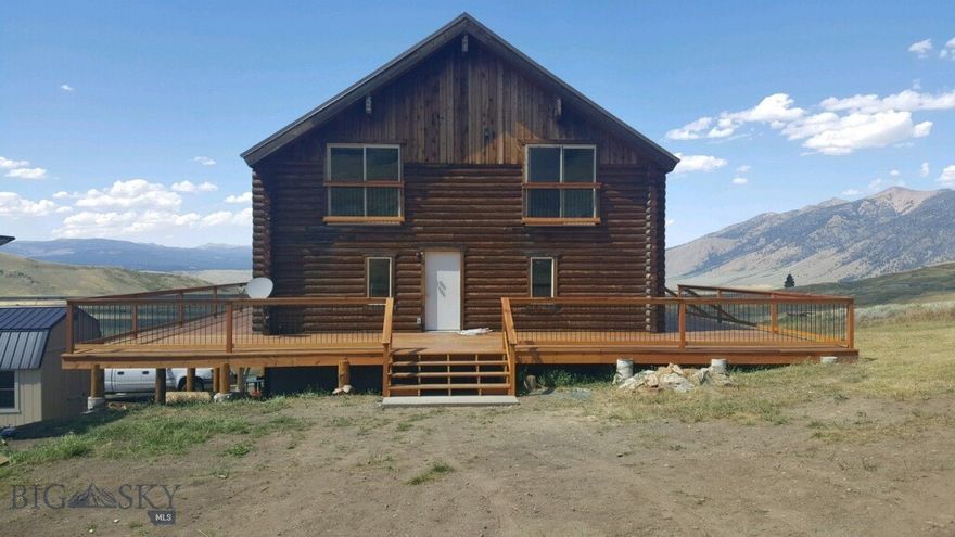 Escape to this cabin nestled on 21 acres, located in the upper Madison River Valley, just short distance  from the National Forest. This retreat offers breathtaking mountain range views and offers a stunning treed backdrop. This custom log home is 3200+/- SF features an open floor plan, vaulted ceilings, wood stove and  large windows to enjoy the mountain and property views. The dining area opens onto the beautiful new redwood deck perfect for entertaining and BBQ's. Upper level is divided into 2 sleeping areas with 3/4 bath between.  Daylight basement includes 1-car garage with large area for boats & storage, has a 900 watt AC/DC Solar power system with a backup propane generator, allowing you to live independently off-grid.  Fish for trout on the World Famous Madison River just a short drive away. With such close proximity to forest service trailheads, Henry's Lake, and Yellowstone National Park just an hour away, you'll have endless opportunities for outdoor adventures. Surrounded by abundant wildlife. Ennis is approximately 40 minutes away and West Yellowstone 30 minute away, you'll have access to amenities while still enjoying the peace and tranquility of your mountain retreat. An ideal spot for anyone who loves nature and outdoor activities! Elk, Deer, Moose and Antelope frequently meander along the nearby mountains and often cross this property. Ideal Vacation Rental.