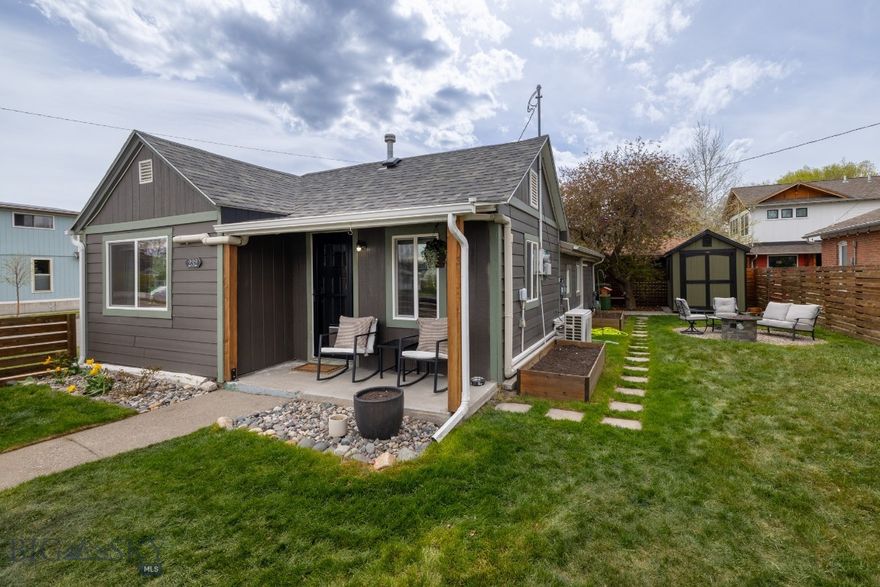 This corner lot home is thoughtfully designed and full of personality. It is irresistibly cute and eclectic and boasts 3-bedrooms with a 3/4 bath. The perfect blend of character, comfort, and outdoor living. It has mini splits throughout and a cellar below for storage.

The fully fenced yard offers a private outdoor space featuring a shed, lush green grass, underground sprinklers, raised garden beds, and a cozy fire pit—excellent for enjoying the summer months, gardening, or simple outdoor activities.

Complete with a covered carport and packed with curb appeal, this home showcases an efficient layout with a natural flow. Ideal for anyone craving comfort, style, and a welcoming feel throughout. It can be sold furnished, too!