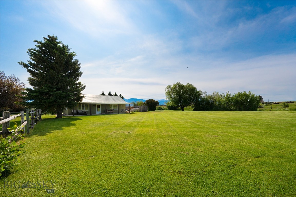 Ride, Hunt, Grow – A Montana Dream! Tucked against open ranchland and minutes from mountain trails and lakes, this 3 bed / 2 bath home on nearly 2 acres offers the ideal Montana lifestyle. Ride, hike, hunt, ski, or fish—adventure starts right out your back door. Inside, the open layout features a remodeled kitchen with quartz counters, newer appliances, a large primary suite, and a Blaze King wood stove backed by propane forced air.
Step outside to a beautifully manicured, landscaped yard—irrigated by a second well—and enjoy outdoor living at its finest. A drip-irrigated greenhouse lets you grow fresh produce year-round, while a 24’ x 40’ shop offers 30 & 50 amp power and an attached carport for your toys or gear. No covenants. Paved access. Space to breathe and room to grow—this is the Montana lifestyle done right.
