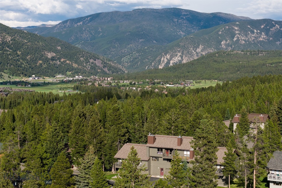 Enjoy breathtaking views of Lone Peak and the Spanish Peaks from this beautifully updated condo, ideally located on a private, quiet street tucked among the trees. Just minutes from local amenities, dining, shopping, and a grocery store, the location offers both convenience and seclusion. Step inside to find a thoughtfully updated interior featuring vaulted ceilings, granite countertops, a custom tile backsplash, and stainless steel appliances. A cozy wood stove adds warmth and charm, perfect for mountain living. Residents enjoy access to a well-maintained association pool, hot tub, and sauna—a true mountain retreat experience. Outdoor enthusiasts will love the proximity to hiking, biking, and skiing, via the extensive trail system, making this home ideal for year-round adventure. Currently being used as a vacation rental and being sold turnkey, fully furnished. Don't miss this unique opportunity to own a peaceful mountain getaway with modern updates and incredible views.