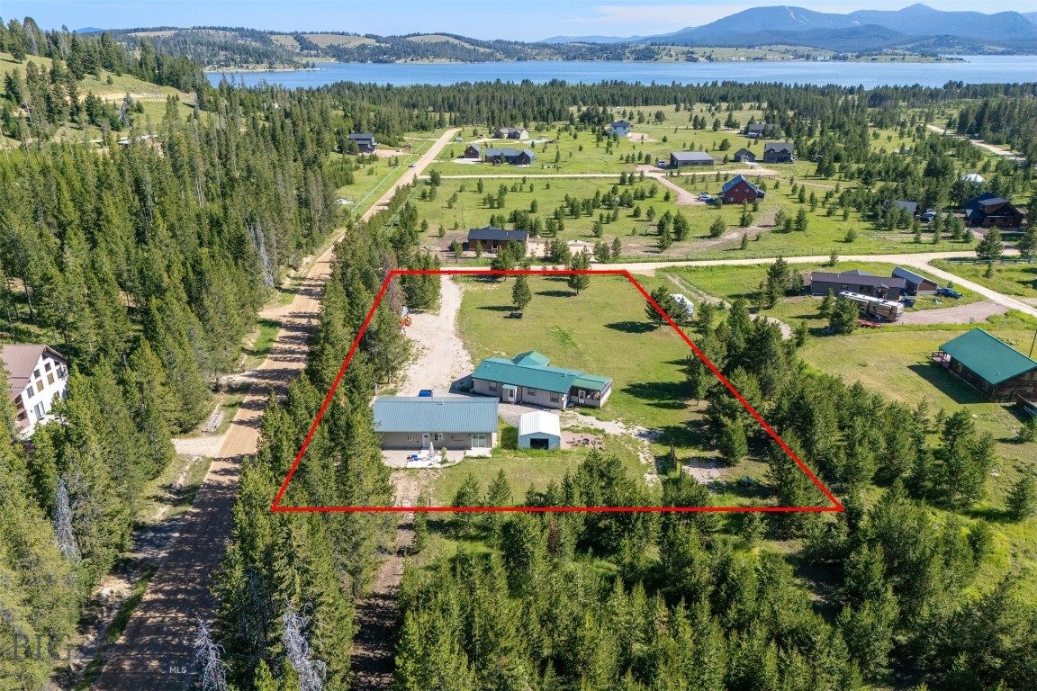 Don’t miss this incredible opportunity to own an income-producing property on two prime lots at Georgetown Lake! Whether you're seeking to build a rental portfolio or simply desire additional space for guests, this property offers everything you need and more. The main residence features three spacious bedrooms and two full baths, all on one convenient level. In addition, you'll find a super cute one-bedroom apartment attached to the garage and a charming tiny home, perfect for visitors or additional rental income. Immerse yourself in the abundant recreational activities this area has to offer, including Georgetown Lake, Echo Lake, the slopes of Discovery Ski Area, and access to thousands of acres of Forest Service land.