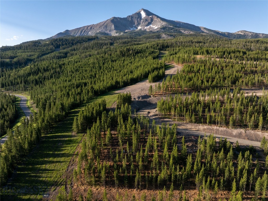 Lot 10 in the Lower Hillside neighborhood in Moonlight West offers 1.02 acres of ski-in, ski-out living with sweeping views of Lone Peak, Fan Mountain, and the Spanish Peaks. As one of the first land offerings in Moonlight West, this homesite is tucked among the pines to create a rare sense of privacy and tranquility, while still offering direct access to the neighborhood trail system that connects into the broader Moonlight West network for year-round recreation. The site is perfectly suited for a custom residence designed to follow the land’s natural contours and maximize view corridors. Located near The Reserve Clubhouse and the future Moonlight West amenities, Lot 10 offers an ideal balance of seclusion and connectivity. Membership in the Moonlight Club is required with purchase and subject to approval.