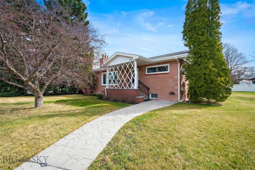 Offered for the first time in over 60 years, this home delivers two bedrooms on the main level, plus three versatile lower-level rooms and a spacious rec room, all on two city lots just two blocks from Main Street.

A home cared for with exceptional pride and consistency over decades. The yard is what immediately sets this property apart. A mature lilac hedge runs along the North side, creating a rare sense of privacy yet manicured to enjoy the Bridger Range in the background, while established trees provide shade, beauty, and a feeling of permanence that's hard to replicate. A peaceful, park-like setting right in town.

Inside, you'll find a thoughtful mix of original character and recent updates. The kitchen was fully remodeled in 2023 with new cabinetry, appliances, and flooring. The main level features a comfortable living room with a gas fireplace, a dining area, and a full bath. (We also discovered wood floors under the carpet!) The full basement expands the living space with a spacious laundry area, ¾ bath, and three additional non-egress rooms offering flexibility for a variety of uses.

Significant improvements have already been completed, including a new furnace and water heater (2024), roof (approximately 4 years old), and new fencing (2024), making this a truly move-in ready home with long-term value.

The location is hard to beat, with easy access to schools, parks, and downtown Belgrade's shops and restaurants, all within walking distance. I-90 is nearby for a quick commute to Bozeman, and the airport is just minutes away. No HOA.

Properties with this much land, privacy, and proximity to Main Street are exceptionally rare. Don't miss it.