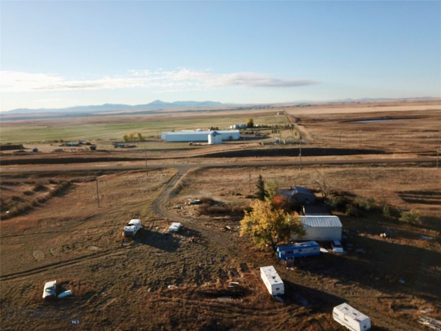 Tucked away on the rolling prairie just 8 miles from Fort Benton, this 13-acre property offers the ideal setting for anyone seeking space, privacy, and potential. With views of the Highwood Mountains and plenty of room to build, this is where your Montana vision can take shape. Build a custom home, barndominium, or a shop big enough to store all your equipment and outdoor toys. A natural spring, roughly 20 feet deep, feeds a cistern on the property, and a few older outbuildings could be cleared to make way for your fresh start. The land’s open layout makes building simple, while year-round access and a short, easy commute to Great Falls, Highwood, or Geraldine add convenience. This location places you within reach of some of central Montana’s most sought-after recreation. Cast a line in the legendary Missouri River, explore the trails and wildlife of the Highwood and Bears Paw Mountains, or head out to Lake Elwell and Tiber Dam for boating, floating, and summer fun. Hunting, hiking, camping, and wide-open exploration await in every direction. When the day winds down, gather around a fire under Montana’s endless starlit sky and take in the peace that comes with country living.