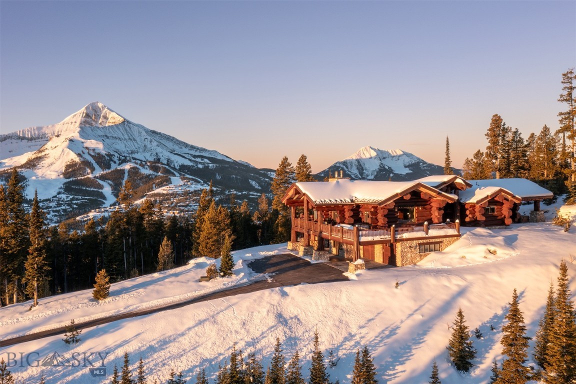 This is the perfect luxury location for those that want to be close to Big Sky's mountain amenities and activities, but still have an oasis set apart from it all! This stunning home with top of the world feel and 360-degree views, has never before been on the market. There are unobstructed views from every window, featuring Lone Mountain most prominently, with generous appearances by Wilson Peak, Fan Mountain, Pioneer and more. Hidden beyond a private gate, the Ridgeview Loop neighborhood of Beehive Basin is pristine and private, close to the popular Beehive trailhead and access to Beehive Lake. The home feels like a lodge, with massive log, timber and rock features, wrap around deck with outdoor fireplace, elevator, sauna, hot tub, all evoking the western flavor you expect in your getaway mountain retreat. There are included plans for an additional guest home that is allowed to be built upon the property. Offered furnished turnkey, with exceptions, featuring many custom, unique pieces and stunning artwork. This masterpiece is ready to occupy on twenty private acres and is just minutes from skiing at the Big Sky Resort and Moonlight Basin, fishing and whitewater rafting on the Gallatin River, and only a short drive to Yellowstone Park and Bozeman, MT. This is a special, one-of-a-kind offering, wonderfully located in this flourishing mountain resort community!