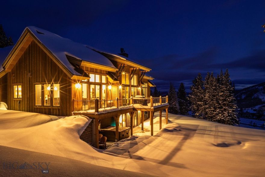 This contemporary mountain home sits on a large Cascade neighborhood lot with direct ski-in/ski-out access to Big Sky Resort, placing skiing, hiking, biking, and year-round alpine adventure right outside the door. Lone Peak, Fan Mountain, and valley views create a dramatic backdrop for every season.

The main level is designed to capture the landscape with an open kitchen, dining area, and great room wrapped in floor-to-ceiling windows. A stone-clad wood-burning fireplace centers the space, while the expansive view deck invites après-ski gatherings and quiet mornings in the mountains. The primary suite enjoys unobstructed mountain views, and a dedicated ski room adds convenience after time on the slopes.

A flexible bonus suite above the garage works as a guest area, rec room, or private retreat. The walkout lower level includes a cozy family room, wet bar, four bedrooms, and direct access to a covered patio and hot tub—an ideal end-of-day ritual after exploring the trails and terrain around Big Sky.

Thoughtful finishes include vaulted ceilings, hardwood floors, and natural wood and stone accents. The hillside setting provides privacy while remaining close to the Mountain Village and the One&Only Resort for dining, shopping, spa access, and lift-served activities. Offered furnished for an easy transition into your mountain retreat.