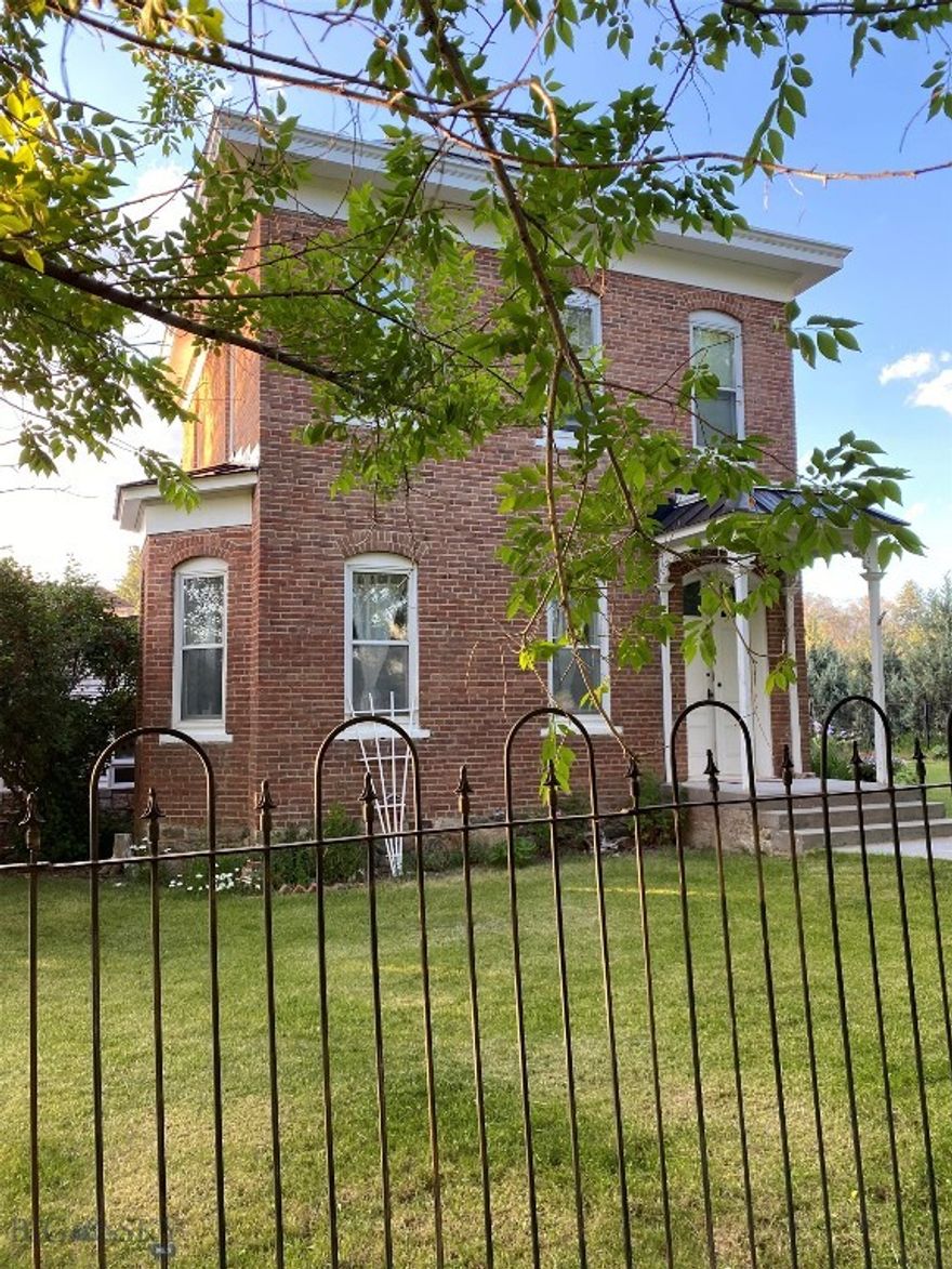 A once in a lifetime opportunity to own a charming historical home with elegant updates. Listed in the National Register of Historic Places, the William O'Brien house reflects the Italian Renaissance Style with a two-story, three-bay facade. Built in 1894 this well-built brick home has every attention to detail including arched brick windows, arched entryways, one of a kind ornate fixtures, fasteners and handles, rod iron fence, and much more. This spacious 2 bed, 1.5 bath home also boasts a reading room, sunroom, library/entertainment room, attached garage with upstairs apartment (1 bd 1 bth, 708 sq ft) and an 1860s log cabin moved from nearby historic Virginia City. Great extra income potential with the upstairs garage apartment in this popular SW Montana destination. The log cabin is a blank canvas to serve such purposes as a shop, guest house or rental - limited only by your imagination! Enjoy the patio area with mature landscaping, underground sprinklers, fruit trees and native Montana flowers. Your friends and family will admire the beauty and design of this historical home with all of the conveniences of a modern house. The O'Brien house is located in the friendly town of Sheridan nestled in beautiful southwest Montana where unlimited outdoor recreational opportunities await. It doesn't get any better than this. Schedule a showing today to truly appreciate this rare opportunity!