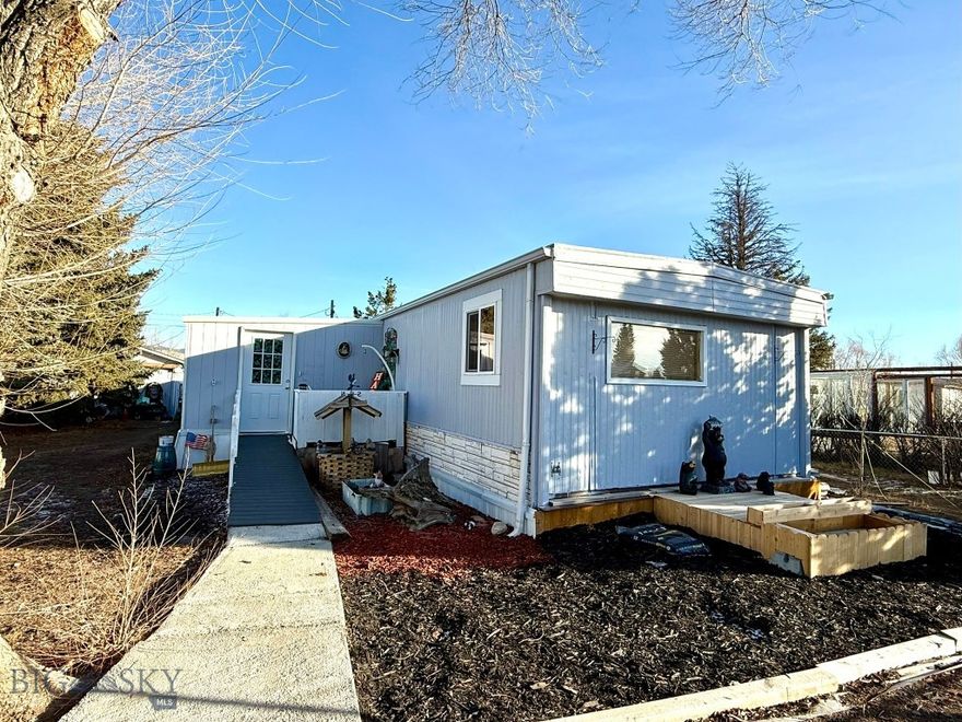 Discover the perfect blend of comfort and practicality in this beautifully maintained 1975 Gallatin mobile home. Spanning 16x88 feet, this one-level residence features a cozy living room, complete with a wood stove, offering warmth and ambiance for your gatherings. The open kitchen, equipped with newer appliances, is perfect for culinary enthusiasts and meals alike. With 4 bedrooms and two 3/4 bathrooms, this home provides ample space for relaxation and privacy. A convenient laundry room adds to the functionality, while the inviting enclosed front porch serves as a play or mud room. The property is completely fenced, ensuring privacy and security for you and your loved ones. It includes a generous 24x32 garage with an attached 16x16 storage area, perfect for all your tools and outdoor gear, along with a nice 12x20 shed for additional storage solutions. This property is a rare find, combining comfortable living with practical amenities - make it yours today!