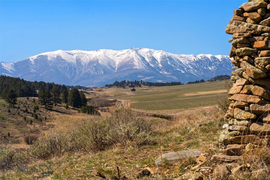 The Buckskin Charley Ranch, an unrivaled rural Jackson Creek Road offering, with a storybook history straight out of the Old West. The original homestead of renowned mountain man, Buckskin Charley Marble. A trusted scout of the Northern Rockies who chose this mountain meadow location to make his own. 
Located in a private valley setting with sweeping snowcapped views from the Bridgers to the Absarokas.  Not in a subdivision, this scenic 20+ acre tract was divided off the main ranch that continues as stock ranch today. A combination of timber, Aspens, natural springs and Marble Creek along native range that attracts a diversity wildlife. Around 25 head of cow elk raise their calves here each Spring. A level 5+/- acres is harvested as wild meadow hay, producing an average of 9-11 ton/year. The property is set up for livestock with outbuildings, perimeter and cross fencing. 
While the majority of original structures are now gone, the ranch offers the same rustic appeal of a by gone era. The vintage two-bedroom residence has been reconstructed from a log cabin with original built ins and hardwood wood floor. Large windows capture the Bridger Range and big Montana sunsets. The expansive kitchen is decked out with custom cabinets made by the homeowner who was a master craftsman. This cozy home sells with all appliances, as well as washer and dryer. The stone chimney is constructed from a meticulous rockhound collection.  The well-constructed historic outbuildings include a livestock barn with stalls, tack room and chicken coop. Also, a solid old granary.  Newer buildings included a 40 X 27 three-bay steel pole barn garage building. Small yard storage shed and new steel woodshed with roll up door. The 48 X 28 carpenter's shop offers several spaces, storage and overhead door. 
Multiple Water rights to transfer with oldest priority date of 1900. This is a special, peaceful valley setting in the heart of the Bangtail Mountains below Green Mountain. Location is accessed via the scenic Bridger Canyon loop on maintained paved roads within 15 minutes of Bozeman and 30 minutes to the airport. Property is zoned Agriculture Exempt in Bridger Canyon Zoning, no known covenants.