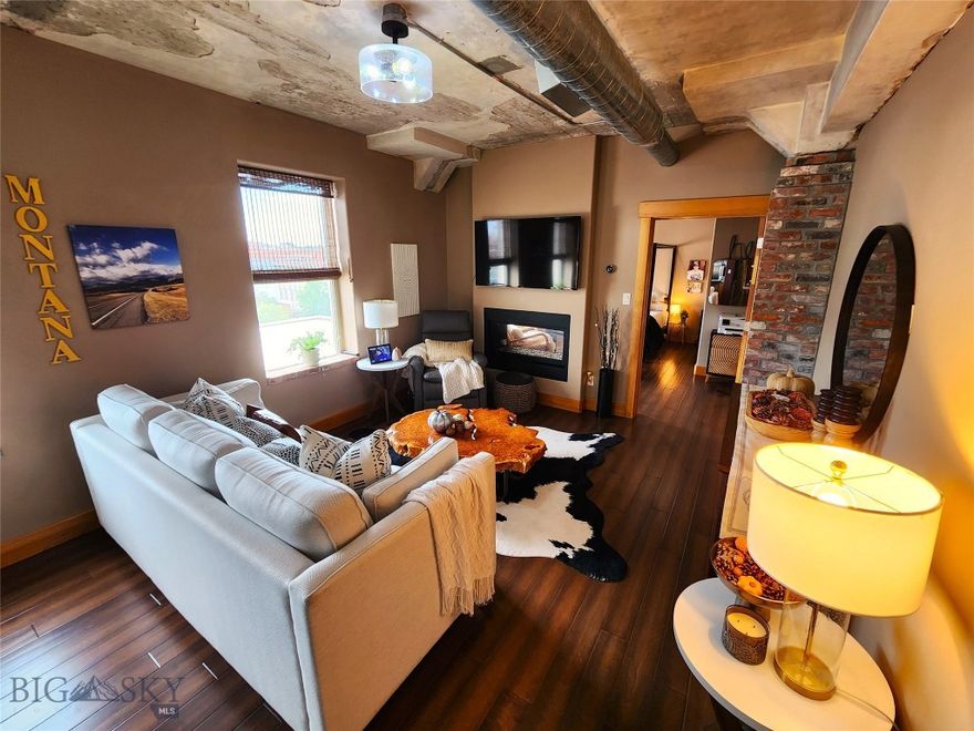 Luxurious Downtown Loft in the Historic Johnson Hotel – Experience refined elegance in this executive condo located in the heart of Great Falls. Set in the iconic, secure Johnson Hotel, this 1,565 sq ft loft blends modern sophistication with rustic charm. Featuring 2bedrooms, 2 baths, an expansive master suite with jetted tub and custom walk-in closet, and an open floor plan filled with natural light. Highlights include hardwood and tile flooring, brick accents, a double-sided gas fireplace, tankless water heater, granite countertops, stainless steel appliances, under-cabinet lighting, solid core doors, smart features like USB ports, Nest thermostat, and Ring doorbell. Enjoy sweeping city views from the fifth floor and direct access to Central Avenue’s vibrant scene. Move-in ready and truly one-of-a-kind, this loft offers historic character with modern comfort.
Other interior features include: an Elevator, Storage in the basement, Built-in Features: Bookcases, Breakfast Bar, Double Vanity, Kitchen Island, Range Hood, Vented Exhaust Fan.