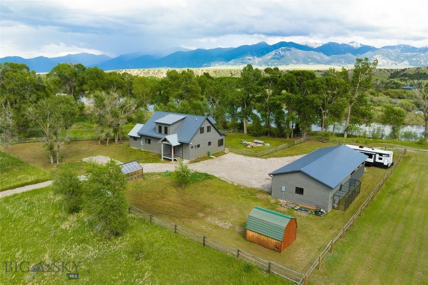 This beautiful private home offers an incredible opportunity for those seeking a nearly riverfront lifestyle. With its modern loft design, spacious interiors, and outdoor amenities, it is perfect for both relaxation and entertaining. The open concept kitchen is designed with painted cabinets, solid surface countertops and a beautifully crafted wood island. Cozy up to the efficient soapstone wood stove on a cool evening in the spacious living room area window facing the River or step outside and entertain guests or enjoy the covered deck and listen to the flowing river water. The Primary main level bedroom is spacious and boasts a beautiful bathroom with a modern double sink vanity and large tiled shower. The loft area has one more private bedroom with a 3/4 shower, and 2 other rooms that can be used as the 3rd bedroom and a workout or office, game or entertainment space. Outdoor buildings include a detached 2 car garage, 3 stall carport, 12'x12' storage shed, and a greenhouse including a heater. Only a narrow strip of Jefferson Acres HOA owned land in between this property and the River as well as to the East. The proximity to the Jefferson River, along with nearby recreational activities, makes it an ideal location for nature enthusiasts. Whether you're looking to enjoy the warmer months fishing, hiking, biking or simply taking in the stunning views of the Tobacco Root Mountains, this property has it all .During the winter months, residents and visitors can enjoy cross-country skiing, snowshoeing, and snowmobiling. While hiking in the area, you may encounter a variety of wildlife, including deer, elk, and moose, which are commonly seen in the Tobacco Root Mountains. Birdwatchers will be delighted by the presence of eagles, hawks, and various songbirds. Additionally, smaller mammals such as foxes, coyotes, and squirrels are often spotted along the trails. Be sure to keep an eye out for unique flora and fauna that thrive in this diverse ecosystem. Furniture/Furnishings are negotiable. Property is in the Floodway.