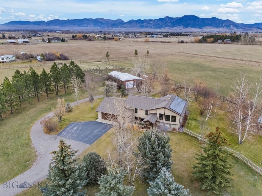 Welcome to your Montana sanctuary! Ten pristine acres just minutes from town, offering the perfect blend of privacy, beauty, and convenience. This meticulously maintained over 2,700 sq ft, 4-bedroom home sits surrounded by mature trees, lush green space, and sweeping Bridger Mountain views that frame every sunrise.  Step inside to find rich hardwood floors, inviting living spaces, and a stunning large fireplace that anchors the heart of the home. The fully finished basement with guest quarters provides the ideal setup for visiting family, extended stays, or possible rental income.  For those seeking a true horse property, this estate is already perfectly equipped. A well-built barn, additional shed, and a charming greenhouse offer endless possibilities, whether you dream of gardening, raising animals, or simply enjoying the peaceful rural setting.  With land designed for both beauty and function, unbeatable proximity to amenities, and views that never get old, this property is ready to become your dream homestead.