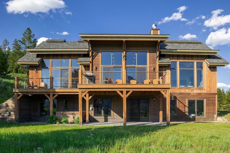 Discover your mountain sanctuary in this stunning ski-in/ski-out retreat near Big Sky Resort. This beautiful home seamlessly combines elegance and functionality, all framed by unmatched views of Lone Peak and Fan Mountain.

The thoughtfully designed main-level layout features the primary bedroom, open-concept living room, dining area, and chef’s kitchen, all positioned to maximize the breathtaking views through expansive floor-to-ceiling windows. A bonus room above the garage offers flexibility as a guest suite, additional rec room, or private retreat. The lower level includes four spacious bedrooms, a cozy family room, and convenient access to the outdoors.

The expansive outdoor living spaces, including a large deck, are perfect for al fresco dining or simply relaxing while taking in the serene surroundings. Designed for versatility, this home provides year-round enjoyment, whether you’re hosting guests or seeking your own peaceful escape.

Nestled within towering pines, this property offers both tranquility and convenience, with immediate access to the slopes and close proximity to Big Sky’s dining, shopping, and recreation. Sold furnished.