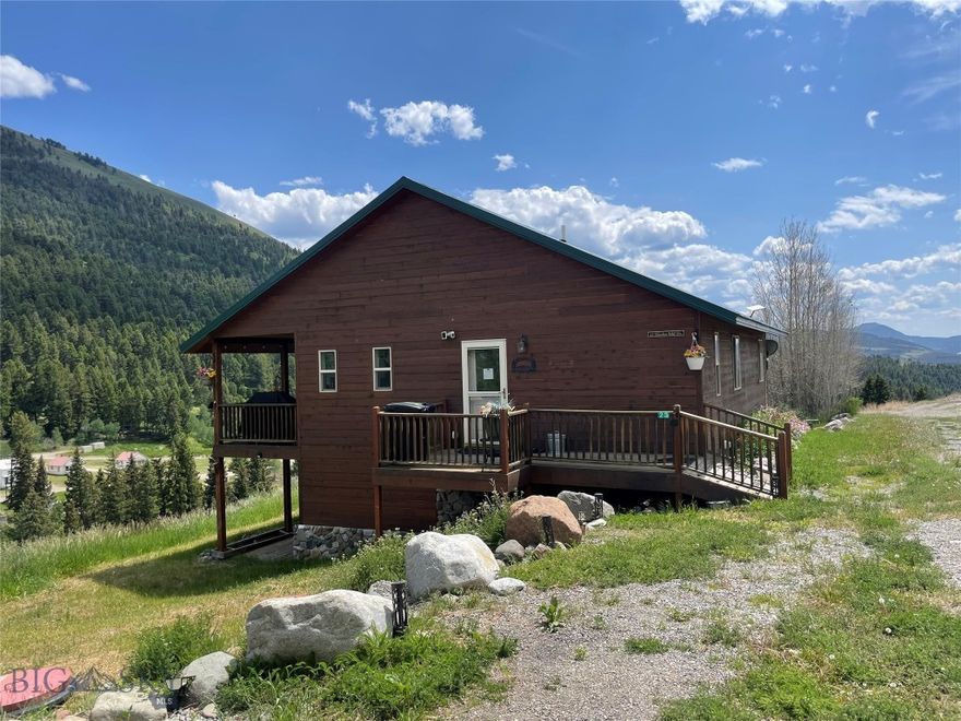 Views, views and more views from this mid-mountain home only 6.5 Miles from Yellowstone National Park. Unwind from city life in the mountains with the security of knowing there are neighbors close by. This property borders the 2 million acre Gallatin National Forest, which is rich in wildlife, scenic alpine vistas, rugged wildlands, and a spectrum of recreation opportunities. This is truly a paradise for big game hunters, photographers, nature lovers and more! Located on 1.87 Acres, this beautiful 3 bed 3 bath home is well maintained with an open concept. The main floor has a primary bedroom/full bath, Guest Bedroom, Guest Hall Bath, Modern Kitchen, Dining area and Living room with loads of natural light. The lower level has a walkout basement to a covered patio, Family Room, the 3rd bedroom, full bath/laundry area. Enjoy the sounds of Bear Creek burbling down below or look out from under the covered deck to old time history of the Jardine gold mine in the distance. Also horseback riding and backcountry trips with nearby outfitters. This can be a year round residence or a vacation home. Feel like you're miles from the city overlooking the small unincorporated community of Jardine. Just 6 miles to the popular tourist town of Gardiner and to the North, only year-round entrance to Yellowstone National Park. Currently a profitable vacation rental that, in the peak of summer can bring as much as $20K in bookings in one month! Schedule a showing today