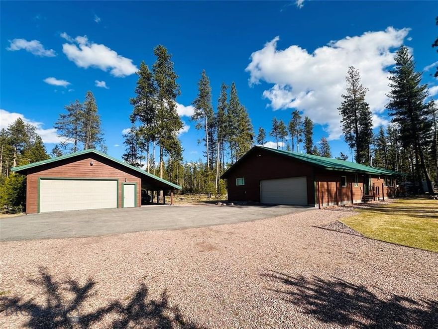 Welcome to 189 Timberlane. This lovely 3-bedroom, 2-bathroom, single-level home has everything you might need. Located in Double Arrow Ranch Phase II, you are close to town, and on the paved road, so you don't have to contend with the muddy spring roads. The home has a bonus room that could be used as an office for those wanting to work from home, or hobby room, or whatever your needs might be. The great room and owner's suite have vaulted tongue and groove blue pine ceilings. You have your choice of heating sources with the river rock fireplace being set up for gas, and a wood stove, also in the living room. There are also supplemental electric heaters throughout the house. The kitchen is complete with a storage pantry, custom hickory cabinets and flooring. The dining room offers access to the expansive 16'x20' covered deck, perfect for outdoor dining or simply relaxing. Trees have been thoughtfully planted surrounding the deck to add to the private feel. A paved driveway leads you to the attached two-car garage which brings you into the tiled floor laundry room. Outside, you'll find the detached and versatile 24'x32' heated shop with lean-to, giving you ample room to store your Montana toys. Attached to the rear of the shop is a 12'x12' shed for additional storage. Across the drive from the shop is a gravel parking pad, and on the south driveway, you'll find an RV parking spot with hook-ups. This area of the ranch is one of the most level and also parklike. The rear yards of the neighboring homes adjoin each other making this homes yard feel expansive. It also feels very private because the neighboring homes to the west sit below a bench and it feels like they aren't even there! Seeley Lake is a recreational paradise and offers just about anything you might want to do outdoors. Whether you enjoy, hiking, biking, fishing, hunting, floating, boating, wildlife viewing, berry picking, off-road vehicle riding, snowmobiling, cross-country skiing,  
snowshoeing, or simply enjoying the endless and spectacular views and mountains, Seeley Lake has it all. Seeley Lake Water District Bond debt service of $32.72 per month until approximately 2029.
