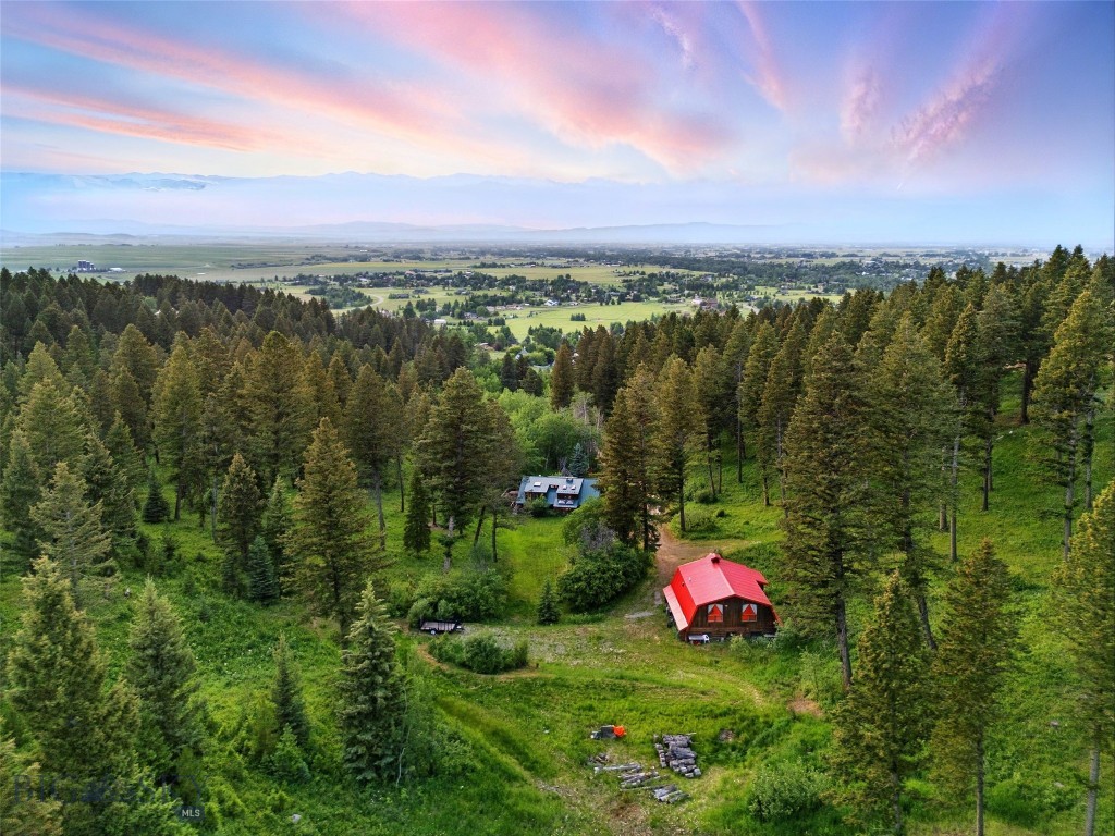 Tucked behind Hyalite Foothills and bordered by Gallatin National Forest on two sides, 750 Black Bear Road delivers a rare blend of privacy, potential, and proximity. Just 15 minutes from downtown Bozeman, this 22± acre forested haven invites you to live immersed in nature without giving up access to modern convenience and vibrant amenities.
From your backyard, enjoy private, direct access to over 580,000 acres of National Forest spanning all the way to the border of Yellowstone, an endless wilderness perfect for hunting, hiking, biking, horseback riding, cross-country skiing, and observing wildlife. Hyalite Reservoir is located just 20 mins away, offering world-class paddling, fishing, camping, and peaceful moments by the water. Despite close proximity to all nature has to offer, Bozeman’s Main Street with its cultural, educational, and culinary energy is just 11 miles away, while the historic Roosevelt Arch - the Ceremonial entrance to Yellowstone Park, lies just 90 mins away.
The 3-bed/2-bath main residence was thoughtfully designed to capture natural light and frame forested views from every window, and a stately stone fireplace anchors the living room, adding warmth and timeless character. The spacious master bedroom provides restful retreat, and a uniquely designed extra room/office inspires creativity and focus, perfect for remote work or artistic pursuits. Outside, a hot tub on the upper deck invites stargazing and relaxation beneath the trees.
Downstairs, the lower-level offers two bedrooms and one bathroom including built-in sauna, a cozy space to unwind after exploring the outdoors.
The large detached garage features an upper-level studio apartment, ideal for long-term guests, caretakers, or a fantastic rental income opportunity. With two wells, water rights, minimal covenants, and a build site on the upper portion of the parcel, this property also offers exceptional development potential which is perfect for a residence, or barn.
Additional practical features include a legally settled driveway easement, and a location just 35 minutes from Bozeman Yellowstone International Airport makes travel convenient and efficient.
750 Black Bear Road is more than a home, it is a Legacy property offering rare harmony with Montana’s wild beauty while staying rooted in connection and possibility. Where forest, freedom, and future potential meet, opportunities like this in Bozeman grow ever more rare.