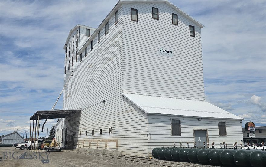 Developer Opportunity – Over 3 Acres with High-Visibility and Historic Structures in Belgrade’s Growth Corridor
Strategically located in the rapidly expanding Belgrade market, this 3+ acre site offers unmatched visibility and access—just minutes from Bozeman Yellowstone International Airport (BZN). Included is a historic grain elevator and office building, primed for adaptive reuse or full redevelopment.
ID zoned for flexibility and priced well below replacement value, this property is ideal for a developer with vision. The site lends itself to a range of commercial uses: destination dining, retail/office conversion, boutique hospitality, or even a mixed-use concept.
The area’s strong population growth, limited supply of unique commercial inventory, and proximity to major transit routes make this a rare investment-grade opportunity. Repurpose or redevelop—this is your chance to turn a legacy property into a modern-day landmark.
20 Year Non-Compete Clause
Seller will convey title to the Property or Buyer by a special or limited warranty deed, subject to a restriction that for a period of twenty (20) years following the conveyance, the Property may not be used for the sale or distribution of agricultural chemicals, seed, or fertilizer.