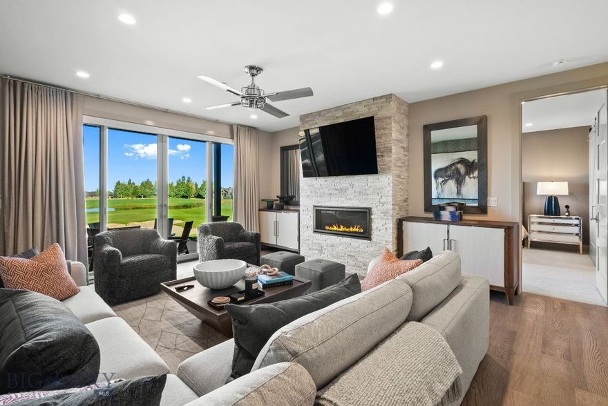 Experience the ultimate in Montana living with this custom-designed walkout Villa, perfectly positioned to capture sweeping views of the golf course, sparkling ponds, and the Tobacco Root Mountains. Inside, every detail has been thoughtfully curated with rich wall treatments, custom window coverings, and high-end finishes throughout. The open-concept living and kitchen area is designed for entertaining, with expansive windows that frame the remarkable scenery & a stone gas fireplace. Two luxurious primary suites each feature private spa-like en suite baths, with one suite opening onto a private patio for a serene retreat. An oversized main patio with built-in gas firepit provides the perfect setting for cozy outdoor gatherings while overlooking the fairways and sunsets. Additional highlights include a large pantry, bar with beverage fridge, beautifully designed powder room, custom closet finishes, upgraded lighting, and refined fixtures throughout. With a lock-and-leave design and unmatched surroundings, this Villa is the perfect blend of luxury and convenience. Just steps away, enjoy Black Bull’s exclusive amenities with an optional Social or Golf membership: a private restaurant, pool, fitness center, championship golf course, and cross-country ski trails. Please inquire for more club membership information. Furnishings, artwork, kitchen items and more are also available separately, please inquire for a true turnkey experience. Some photos are club amenities. Don't miss the Virtual Tour!