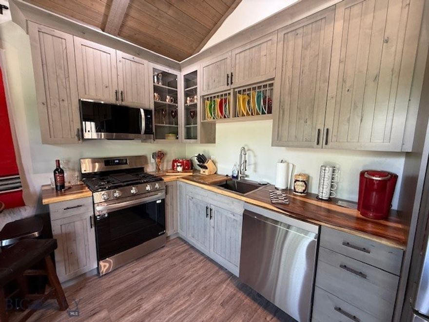 Beautiful Cottage right on the fly-fishing creek Warm Springs and adjacent to the Jack Nicklaus Signature Golf Course, Old Works in the cool popular historic Anaconda. 
These individual Cottages are built with high-end materials and are able to be rented out nightly, weekly and monthly. Great rental history to Traveling Nurses, short term executives, golfers and vacationers enjoying all the natural wonders and history Anaconda offers. This Cottage has luxury vinal flooring for easy care, a stone gas fireplace in the living/dining area, high-end kitchen cabinets, stainless LG appliances in the gourmet kitchen...all overlooking the deck and the creek. The countertops are custom acacia wood. The spa bathroom has dual vanities with copper sinks on custom acacia wood counters. In a separate bathroom area is a huge, tiled shower with dual shower towers and multi-head nozzles and glass shower enclosure, next to an oversized two person jetted tub!
The bedroom has a large area for a king-sized bedroom suite and two closets- one large walk-in and one lockable owner's closet for all your fishing and ski equipment!!!!! There are also garages available to purchase separately from $59,900. Agent has an ownership interest in the property.