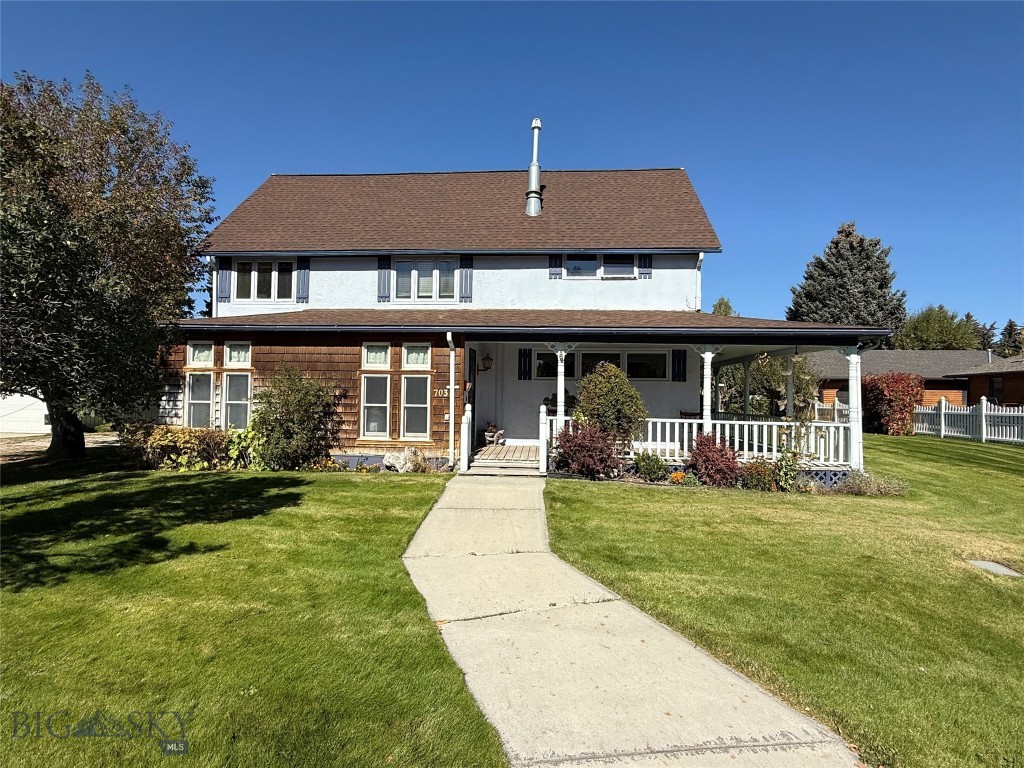 Introducing a charming gem with a rich history, this beautifully maintained home offers the perfect blend of comfort and character. Enjoy the convenience of main floor living, featuring a welcoming back entry that includes a well-appointed laundry area, a cozy kitchen with an informal eating nook, and a dining area enhanced by a gas fireplace - perfect for gatherings. The spacious living room provides a warm and inviting atmosphere, while the primary bedroom includes an attached bathroom for added privacy. An additional 3/4 bathroom and enclosed front porch complete the main level, offering a serene space to relax. Venture upstairs to discover an open office or hobby area, along with two additional bedrooms and a convenient half bath, making this home ideal for those who need extra space. Unique features abound, including stunning stained glass windows and doors that flood the home with natural light. The exterior is a true showstopper, resembling a picturesque scene from a home and garden magazine, complete with a meticulously landscaped yard, vibrant flower beds, a productive vegetable garden, and a tranquil water feature. For the car enthusiast or hobbyist, the oversized insulated two-car garage with a cozy wood stove is a dream come true. Additional amenities include a covered RV parking area and two storage sheds, ensuring you have all the space you need for your outdoor activities and tools. With the distinction of having the first well in town, this home combines history with modern living. Don't miss the chance to own this exceptional property that offers both beauty and functionality!