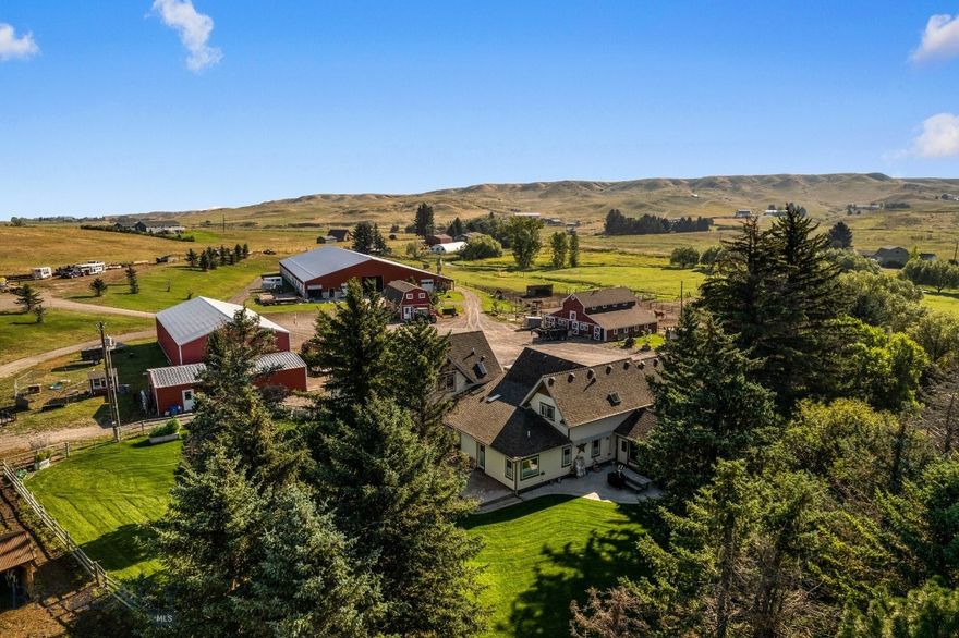 This property is a dream for horse enthusiasts and the perfect small ranch operation. If you've been looking for a property that has it all, this is it!! Settled amongst Camp Creek, cottonwoods, lush farm land and stunning views, this premier equestrian estate on 96± deeded acres in Gallatin Valley is just 15 minutes from Manhattan & Belgrade, or 25 minutes from Bozeman. This unique offering features a 4900+/- SF home (prepped for remodel), extensive horse facilities, productive irrigated ground, and Camp Creek meandering through the property. The ranch includes 40± acres of wheel-line irrigated fields, 49± acres of native pasture, and 10± acres of improvements. Amenities include an expansive indoor riding arena, indoor/outdoor boarding facility, tack room, outdoor arena, ample hay storage, two historic barns, machine & equipment shops, a gym and "trophy" space, and well-designed paddocks. The ranch previously supported a boarding operation and yields about 200 tons of grass/alfalfa hay annually. The main home, originally a historic farmhouse, was renovated in 2011 with a large addition. The home is currently in a “ready to remodel” condition. Sheetrock & taping will be completed at list price. Original cabinets, vanities, counters and trim are left on site for the next Buyer, reducing cost of completion. Bring your vision to make it your own! 40 Shares of Low Line Canal are included for irrigation. With rural views of the Spanish Peaks and Bridger Mountains, mature trees, creekside and an irrigated backyard oasis, this productive ranch offers the perfect blend of function, beauty, and potential in one of Montana’s most desirable locations. Some interior images are AI images to assist with "remodel vision." Sheet rock and taping will be completed, then home and property is to be sold as-is. Photos of the home prior to demo can be shared upon request.