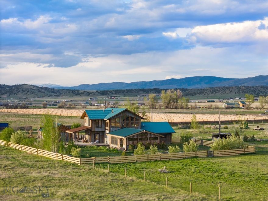Serenity, function, and craftsmanship converge at 11111 Juniper Road in Three Forks, MT - an extraordinary, self-sustaining homestead just steps from the Missouri River and right near BLM and state land.  Built by the same master craftsman behind the iconic round barn at Headwaters Ranch, this beautifully constructed estate is more than a home, it's a lifestyle. The main house stuns with aged timber beams, walls of windows that flood the space with natural light, and a seamless blend of tile, stone, and wood flooring throughout. The well-appointed kitchen is equipped with granite countertops and stainless steel appliances, perfect for preparing homegrown meals.

Upstairs, the spacious lofted primary suite offers privacy and peace with its ensuite bath and walk-in closet. Enjoy access to the wraparound covered/open porch from several locations - your front-row seat to breathtaking Montana mountain views, endless skies, and the calming song of chirping birds. The massive, partially insulated shop offers room for tools, toys, and all-season projects, while the large greenhouse supports year-round growing. Enjoy sustainable living with your own chicken and duck coop, pig pen, and multiple raised garden beds and planters. The land is also ideal for horses, offering open space and a layout built for functionality.

This property supports a true homestead lifestyle - quiet, self-sufficient, and grounded in nature - yet it’s located just off the highway and along the local school bus route, making access seamless. The two-bedroom guest house, complete with kitchen, full bath, and living space, provides perfect quarters for extended family, guests, or additional rental income. Whether you're unwinding on the porch, tending to your hobbies, or soaking in the stillness of the countryside, 11111 Juniper Road invites you to slow down, breathe deeply, and live a Montana rooted lifestyle.