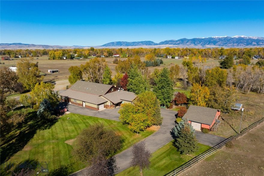 THREE DWELLINGS, 11+ ACRES, TWO SHOPS, LIVE WATER & LIMITLESS OPPORTUNITY. This multi-family compound is situated on 11.5 acres with the beautiful Baker Creek flowing through, incredible Bridger Mountain Views, huge equipment storage, and lush livestock pastures. The main house includes 3 bedrooms, 2 bathrooms, dedicated office space, multiple flex rooms perfect for in home gyms, game rooms, dens and more. Upstairs, there is a large and comfortable 2 bedroom, 1 bathroom, fully appointed apartment with it's own private entrance. The attached shop space is unparalleled, with a heated 3,250 sqft complete with a full kitchen, bathroom, built-in storage, attached additional workshop, and drain system. If that storage space isn't enough, also included is an additional detached, 1,092 sqft shop and two more additional garage spaces. The 5 star level 10 Exceptional Rated guest cabin, affectionally known as the "Cabin Sweet Cabin" has been beautifully renovated boasting 3 bedrooms, 3 bathrooms, a loft, covered patios, hot tub and more. Currently used as an extremely successful vacation rental, the guest cabin is sold beautifully furnished and turn key as an income producing property. There are minimal covenants and no HOA here. This property was formerly home to a large scale construction company and promotes itself so well to live/work opportunities, while simultaneously offering guest space and SUBSTANTIAL rental income production. This property could easily accommodate multi-generational living or serve as simply an incredible investment opportunity with several rental income avenues. Located at the very end of the road, bask in a quiet, rural setting with fenced livestock pastures, chicken coops, firepit, irrigated garden areas, a beautiful creek that attracts regular local wildlife, mature trees, and a Bridger Mountain backdrop. This home is truly unique and provides soo many opportunities that are becoming increasingly difficult to find. Located off of Amsterdam road, your commute to Bozeman, Belgrade, Manhattan and the Bozeman Airport are a breeze. Let your imagination run wild and make this your dream HOME SWEET MONTANA HOME today!