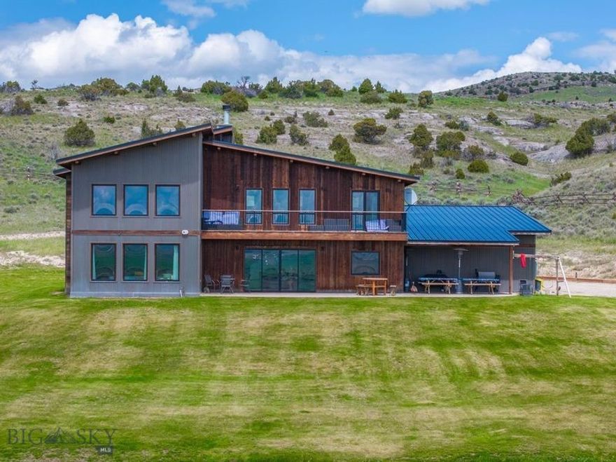 Modern Custom Home on 22+ acres with Stunning Mountain & Valley Views!

This breathtaking modern-style custom home, built in 2019,  blends sleek design with comfort. Step inside to a soaring vaulted ceiling, radiant concrete floors, and rich wood accents that create a desirable modern vibe throughout home. Expansive southern-facing windows capture panoramic valley and mountain views, filling the home with natural light.

3527 SF beautifully designed living space includes 5 bedrooms, 3 1/2 baths, and 1096 SF unfinished basement.
Designer kitchen with concrete counters, island, wine cooler, under cabinet lighting, pantry and backsplash to ceiling makes this a cook's dream! Step right outside for summer BBQ's and al fresco dining with a view! Perfect for entertaining or casual meals. 

Quadfire wood stove and stacked stone fireplace with timber accents draws your attention to the contemporary open concept. 

The home office area on the main floor offers the ideal remote work set up with more inspiring views!
Vaulted living area with loft-style architecture seamlessly connects lower and upper levels. 

Upstairs includes a sizeable master en suite  featuring a walk-in tiled shower with a steam unit for ultimate relaxation and separate soaking tub. The bedroom boasts stunning southern views, complemented by stylish wood accent walls that add warmth and character to the space.

Upper bonus room/living area  has access  to a private deck—perfect for enjoying the fresh air with your morning coffee! The two additional upstairs bedrooms have their own full  bathroom.

Situated on 22+ acres, home offers  end-of-the-road privacy and fenced land.
Built into the hillside for added seclusion. Located in coveted Gallatin River Ranch neighborhood with private its access to 2 1/2 miles Gallatin River, boat launch in Picnic pavilion park and 640 acres state land.
Don't miss out—schedule a showing today!