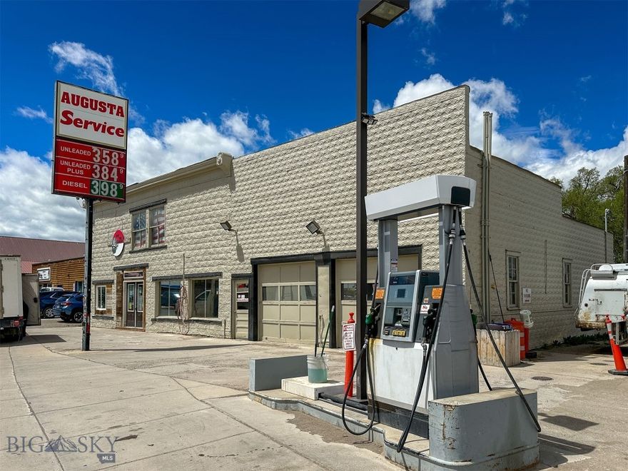 SELLERS WILL CONSIDER FINANCING! If you are looking for an affordable AND successful commercial property in which to invest, The Augusta Service Station is it! Included in the sale is a charming gas station on a state hwy and the main street of Augusta, MT, plus another lot that houses fuel holding tanks and a shop. The sale ALSO includes 2 new credit card pumps, 2 fueling tank trucks, compressors, shop tools, tire equipment, tires, POS, inventory and more. It is being sold turn-key! From an investment standpoint, there are so many opportunities to increase already solid revenue. Sellers have just begun adding a convenience store. It is ideal for other retail, expanded mechanical service offerings, storage, U-Haul, etc... NO ZONING and in an unincorporated city. The next closest gas station is about 20 min away, so you are the only stop for most travelers and locals. Primary space is enormous w/ garage bays, storage, office space, and an unimproved upper level.  
The upper level space could possibly be converted to living space or inventory storage. The fueling tank lot has a big metal shop, tanks and views of the Rocky Mountain Front. That shop could also be converted to retail, storage and more. Electrical recently replaced in most of the gas station and all of the shop. Total acreage is over an acre with all of the lots. Exterior retains some of the original old world style with metal siding and fancy cornices. Bring your ideas and upgrade your lifestyle to small-town Montana living while making a living! The package includes 426 Manix Street AND 130 Main Street.